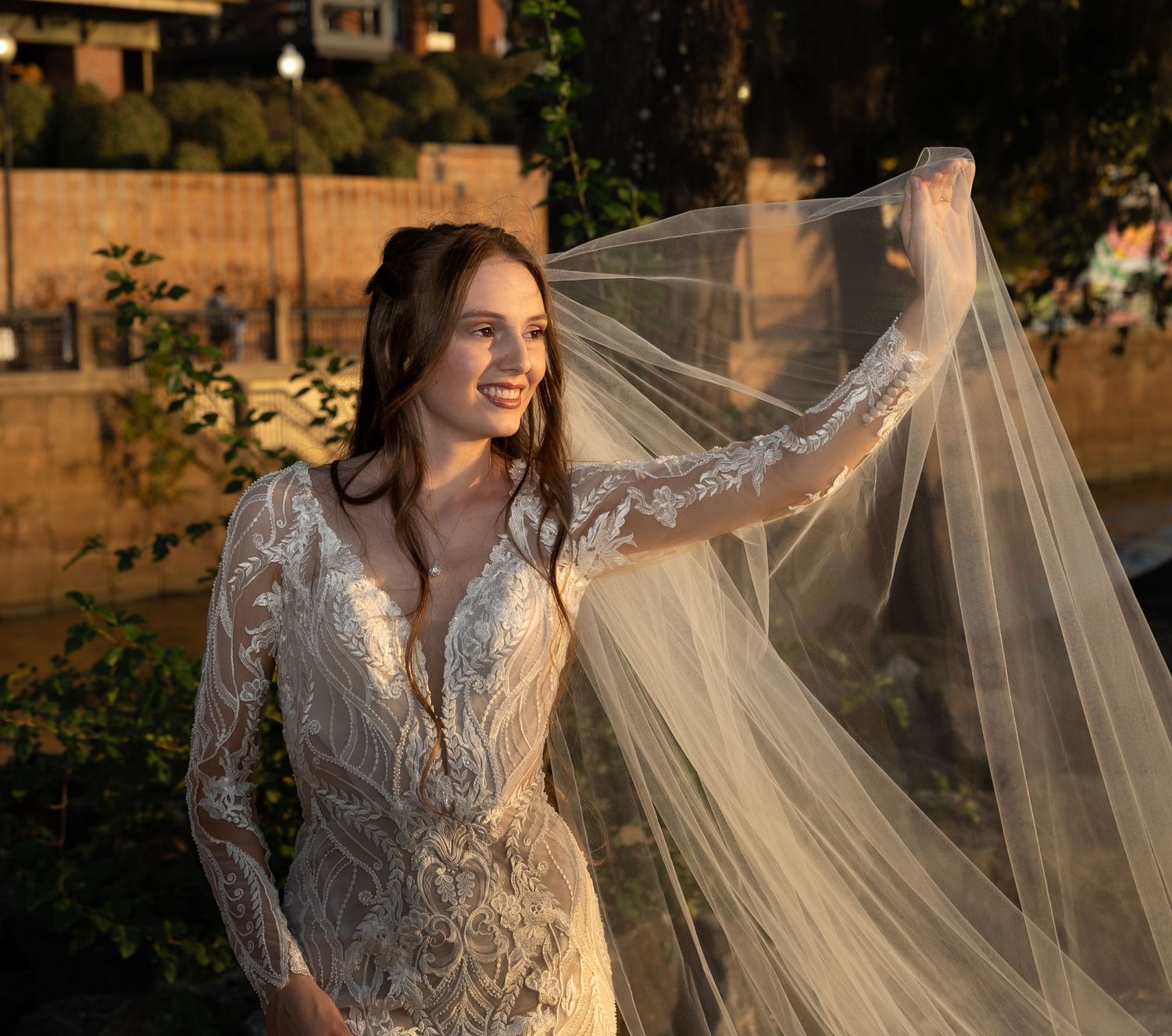 A series of sunset bridal portraits featuring a lace wedding gown and flowing veil.