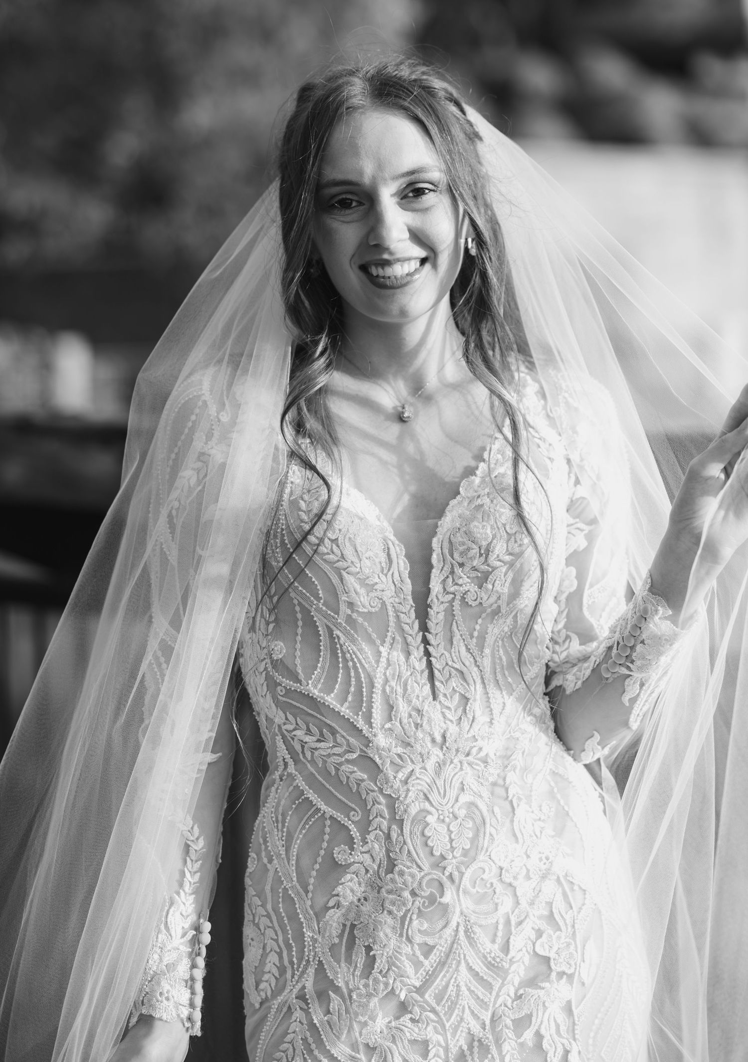 Black and white bridal portrait series highlighting delicate lace details and veil.