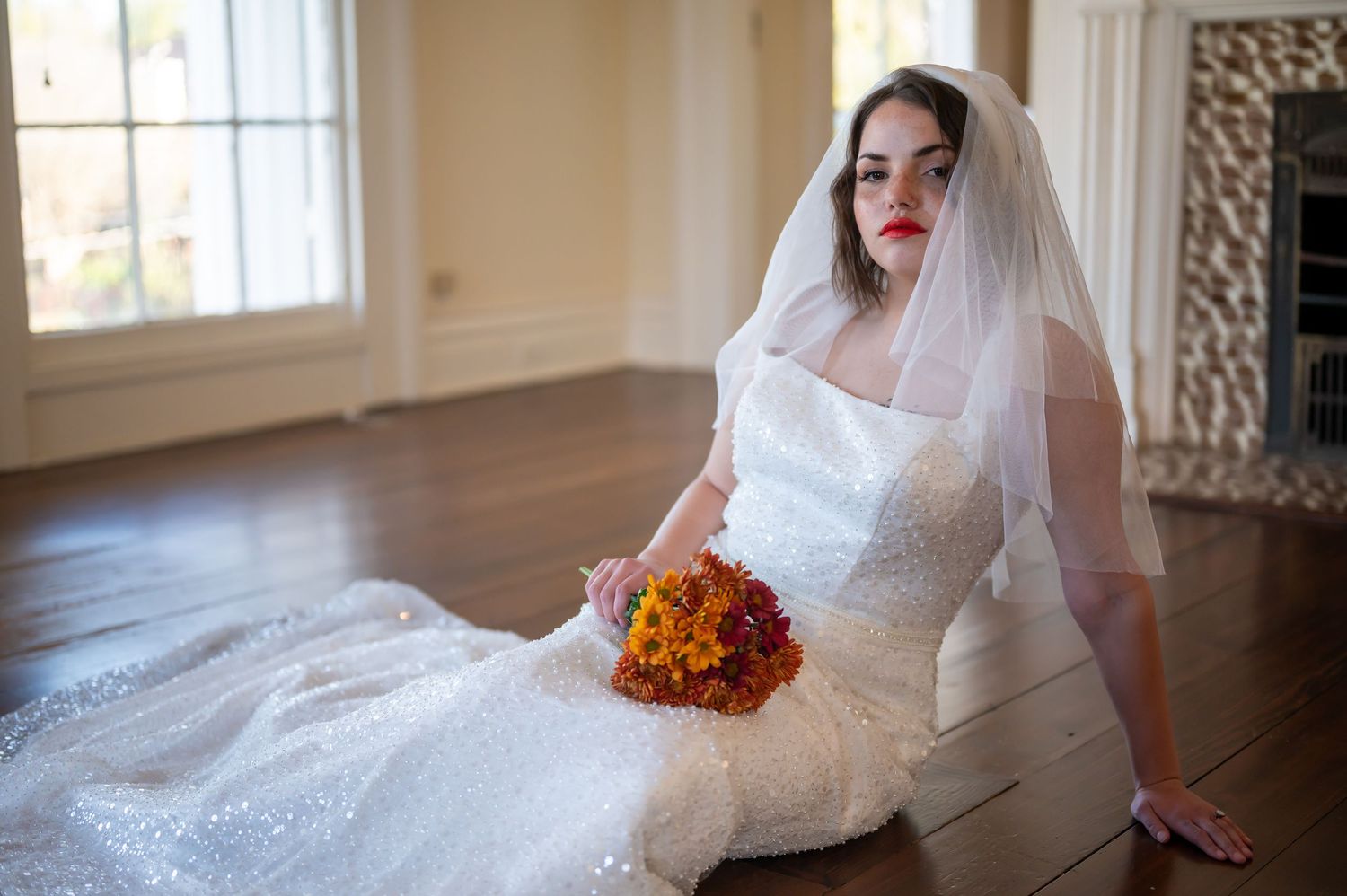 Natural light bridal portraits featuring a white lace wedding dress, delicate veil, and autumn-colored floral bouquet.