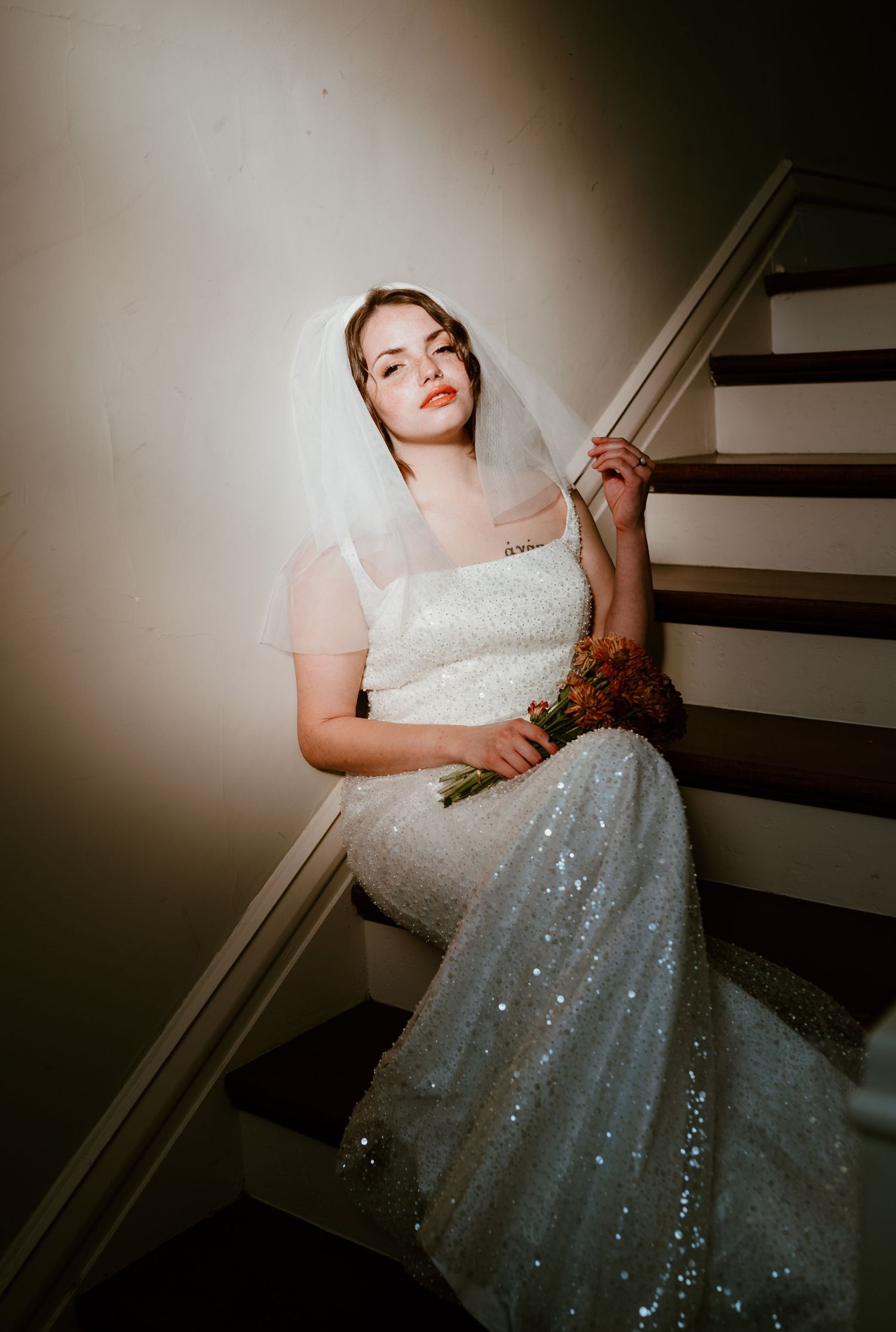 A sequence of moody wedding dress photos on stairs showcases sparkling details in dramatic lighting.