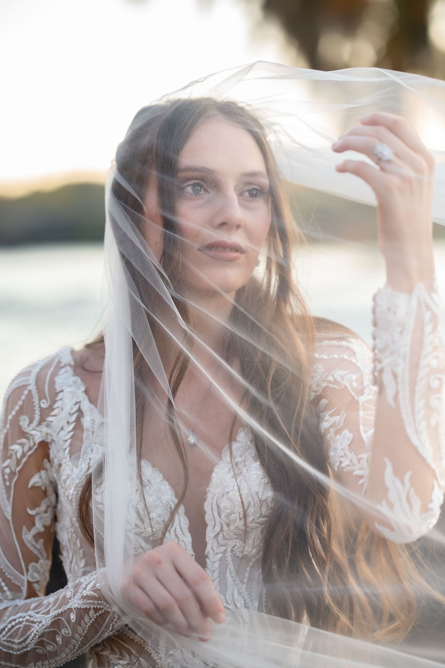 Romantic bridal portraits with soft lighting and flowing veil creating dreamy atmosphere.