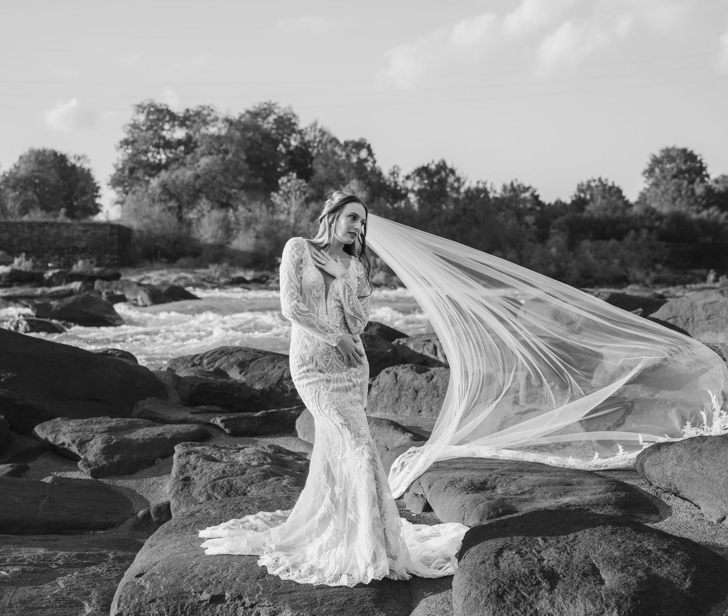Black and white bridal photos showing a flowing veil against dramatic rocky landscape.