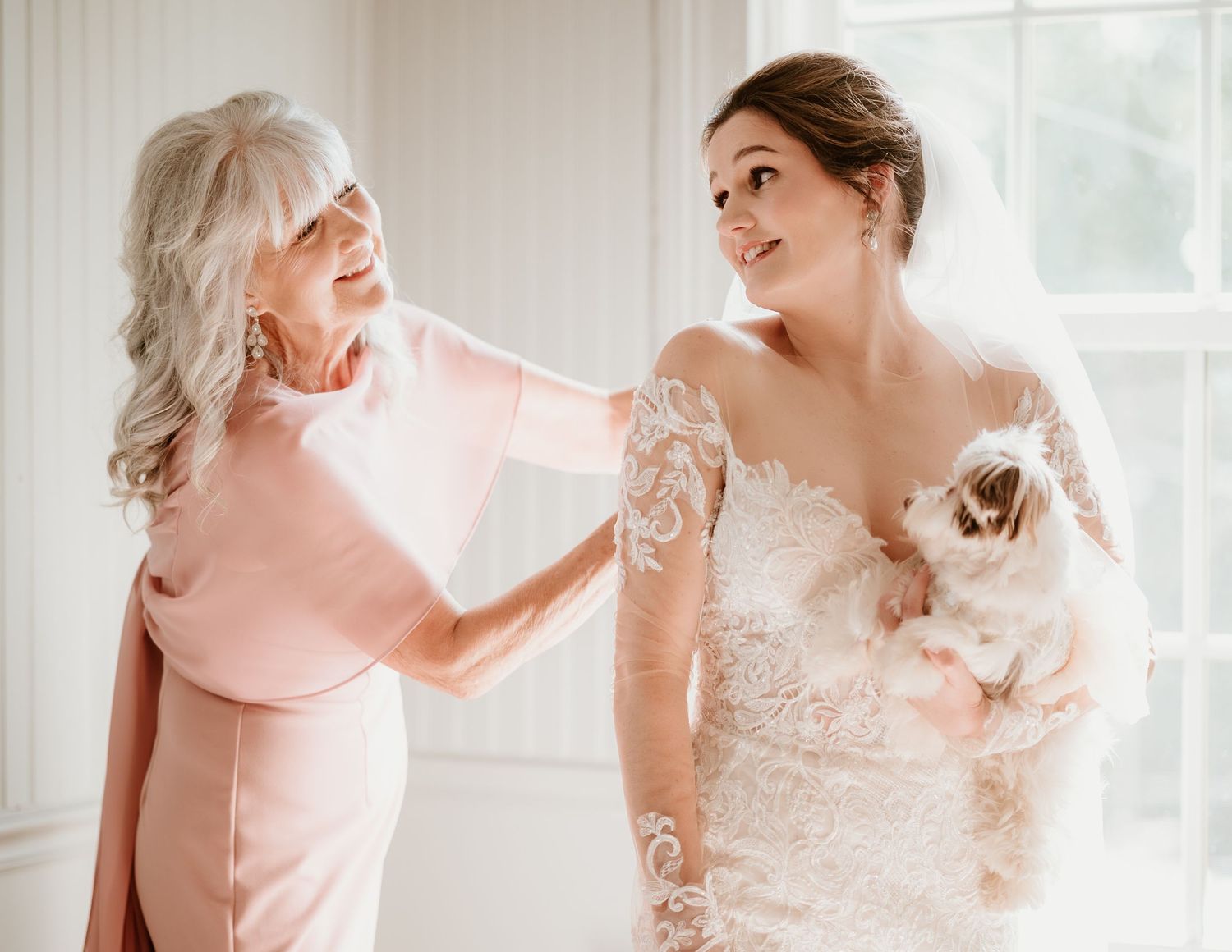 Candid getting ready moments with bridal party in light-filled room.