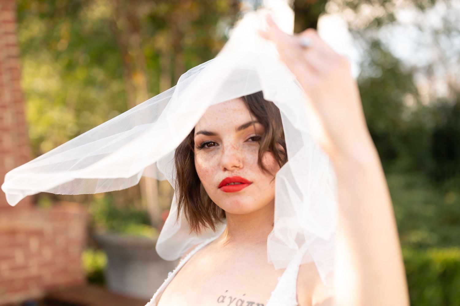 A vintage bridal portrait series showing delicate white veils and romantic lighting in a garden setting.
