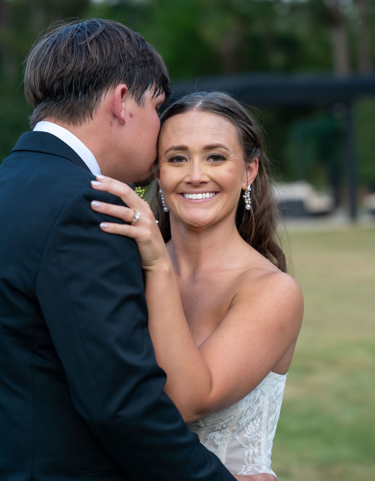 Romantic wedding couple shares an intimate moment during their outdoor photo session at sunset.