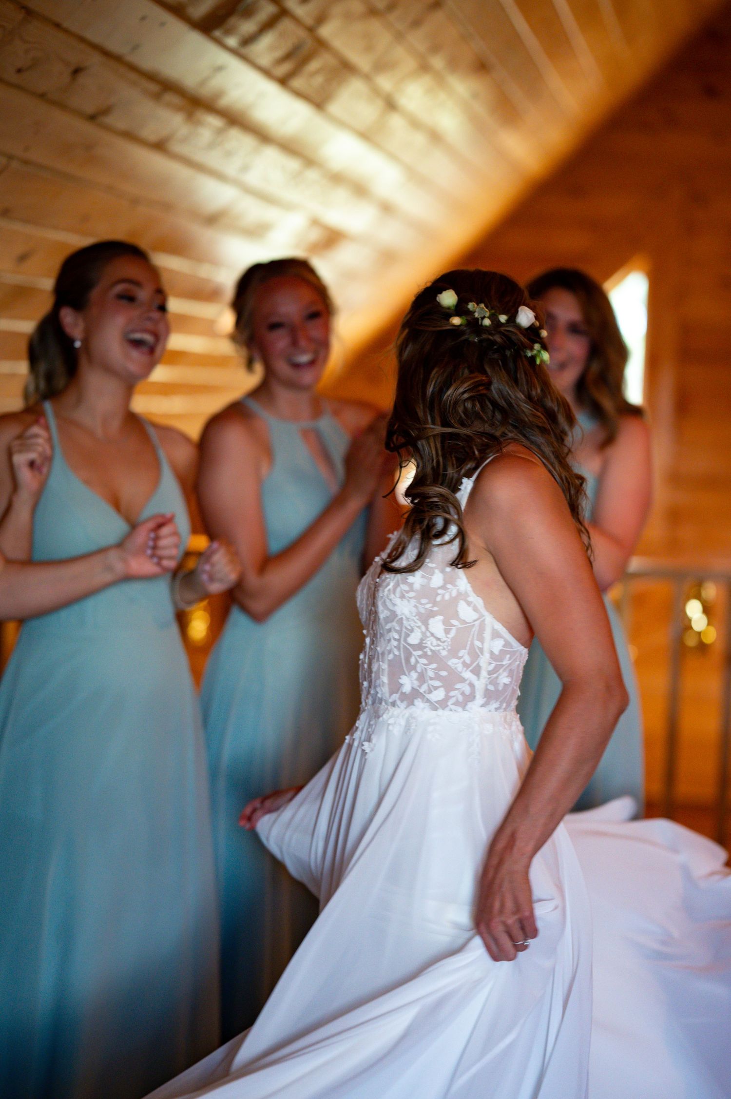 Bridesmaids in light blue dresses gather around a bride in white.