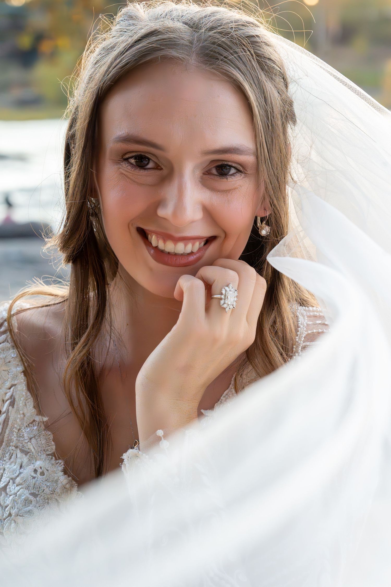 Ethereal bridal portrait series with delicate veil and lace details in natural outdoor setting.