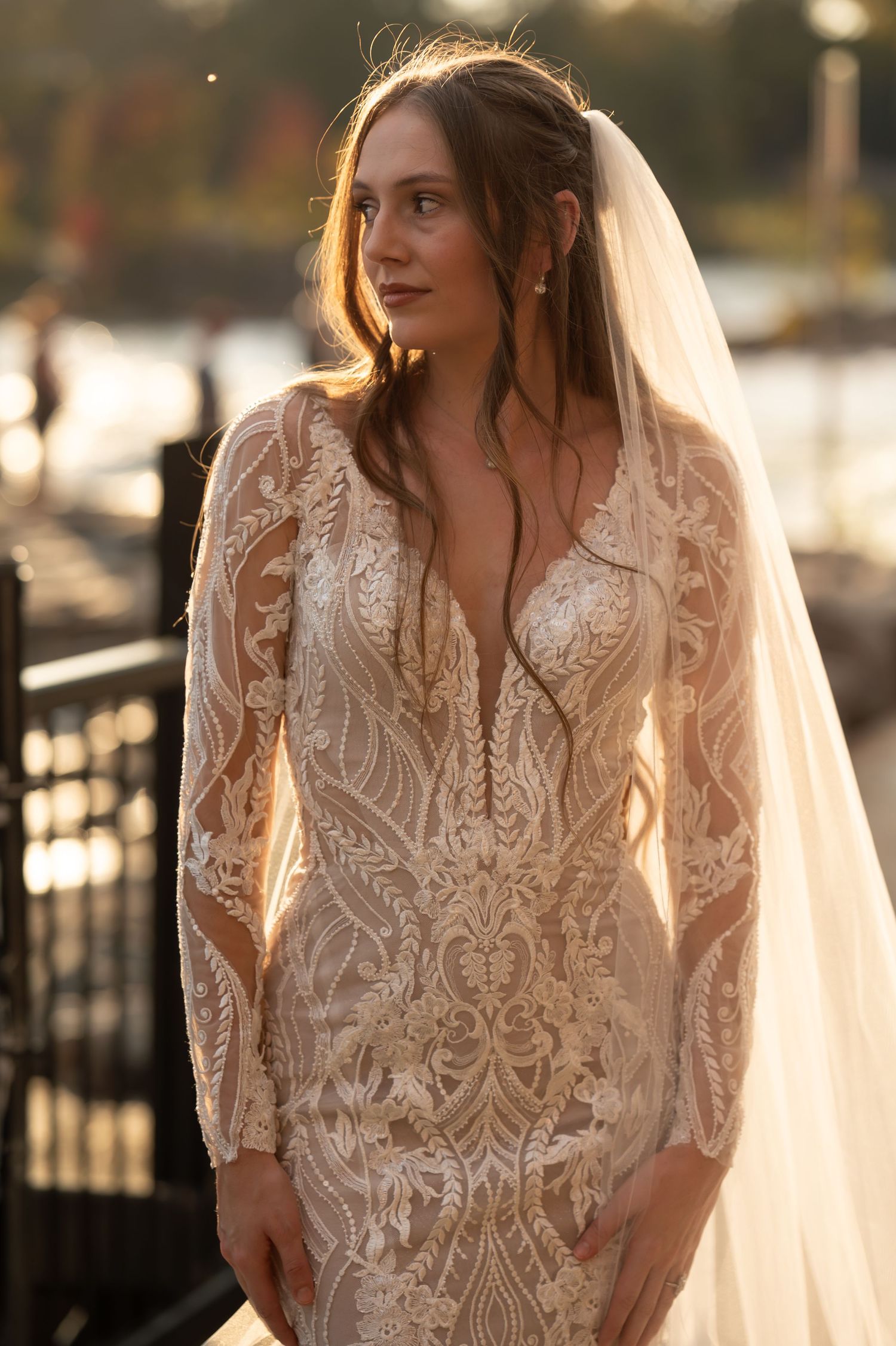 Close-up bridal photos showcasing intricate lace detailing on a romantic wedding dress with sheer elements.