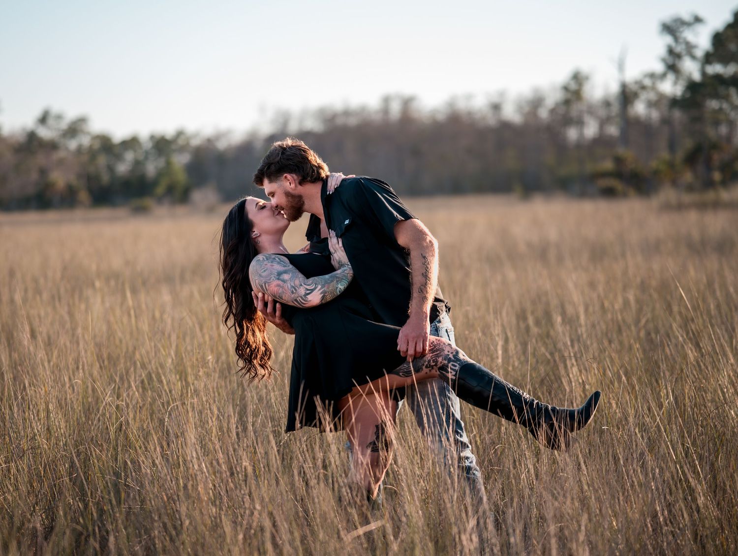 Dramatic dip pose captured during couple's outdoor photo session.