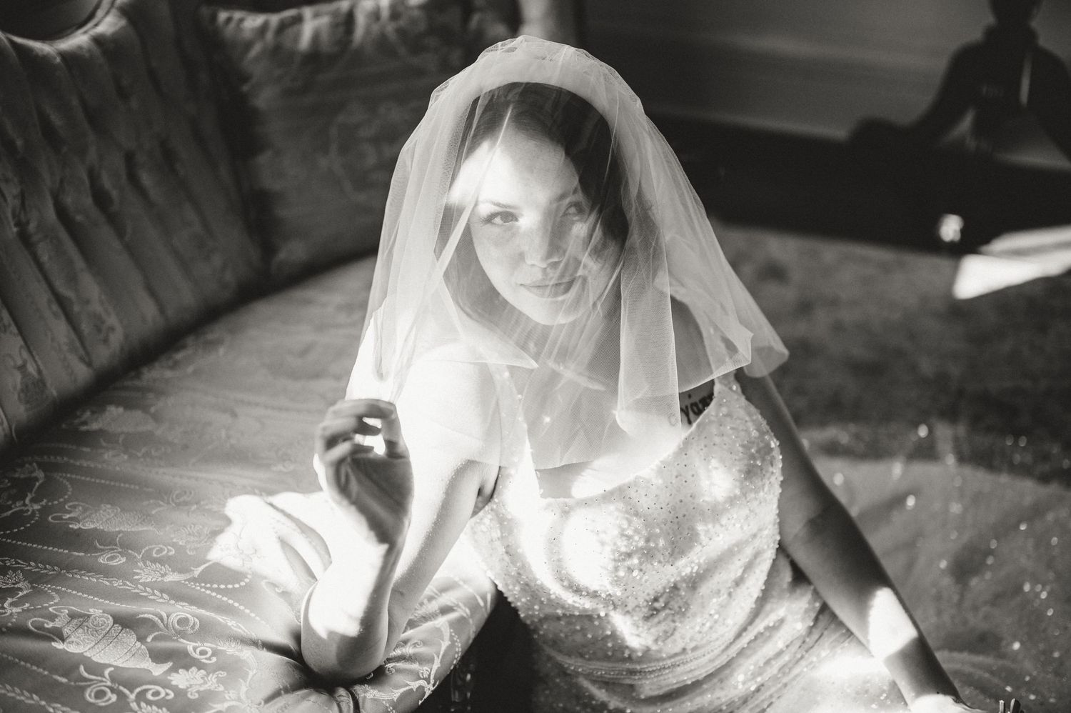 A monochromatic photo series showing different angles of a person wearing a traditional wedding veil and gown.