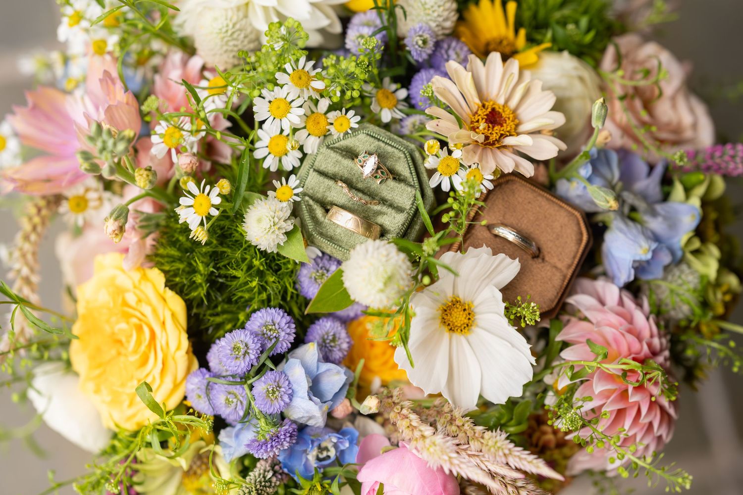 Wildflower wedding bouquet featuring colorful daisies, sunflowers and delicate blooms.