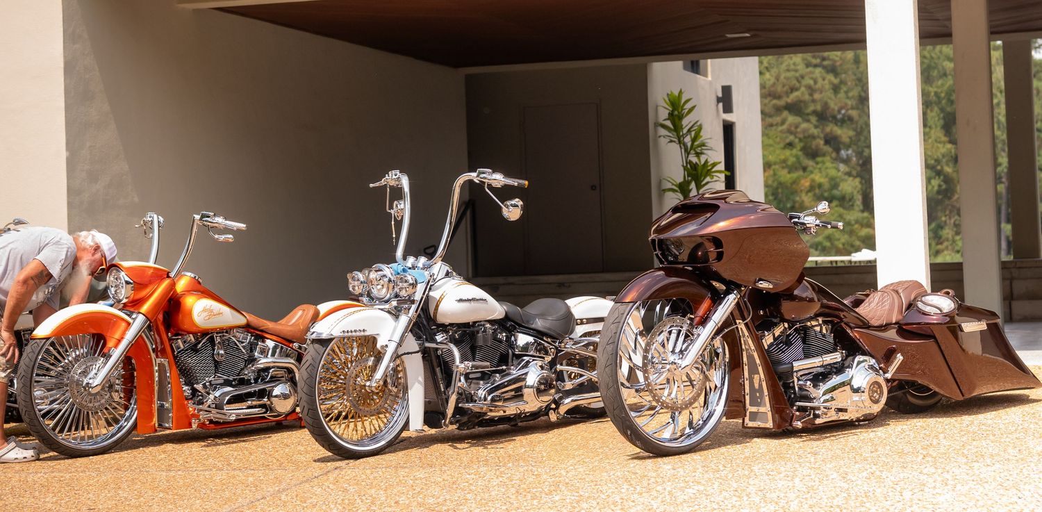 A row of vintage motorcycles and scooters lined up on display showing various classic models and styles.