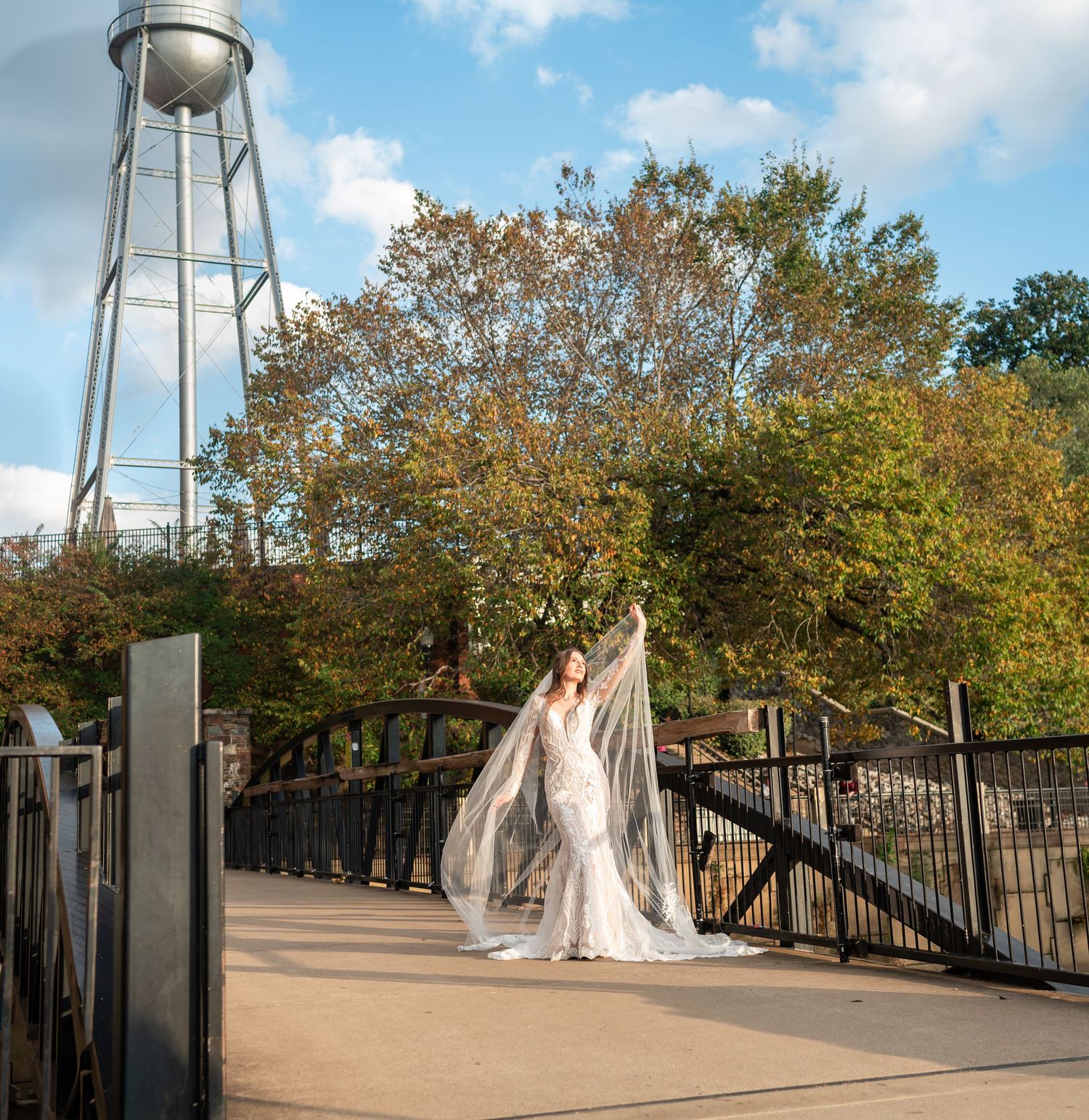 Industrial water tower and bridge setting for outdoor bridal photography.