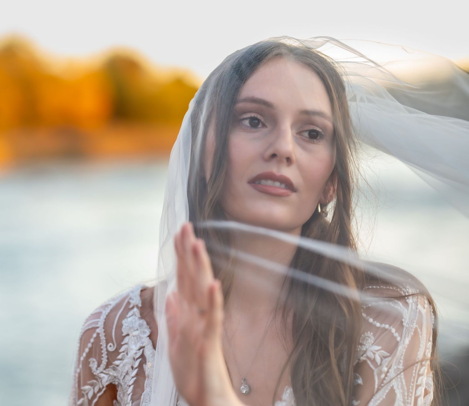 Ethereal close-up bridal portraits with veil in golden sunset light.