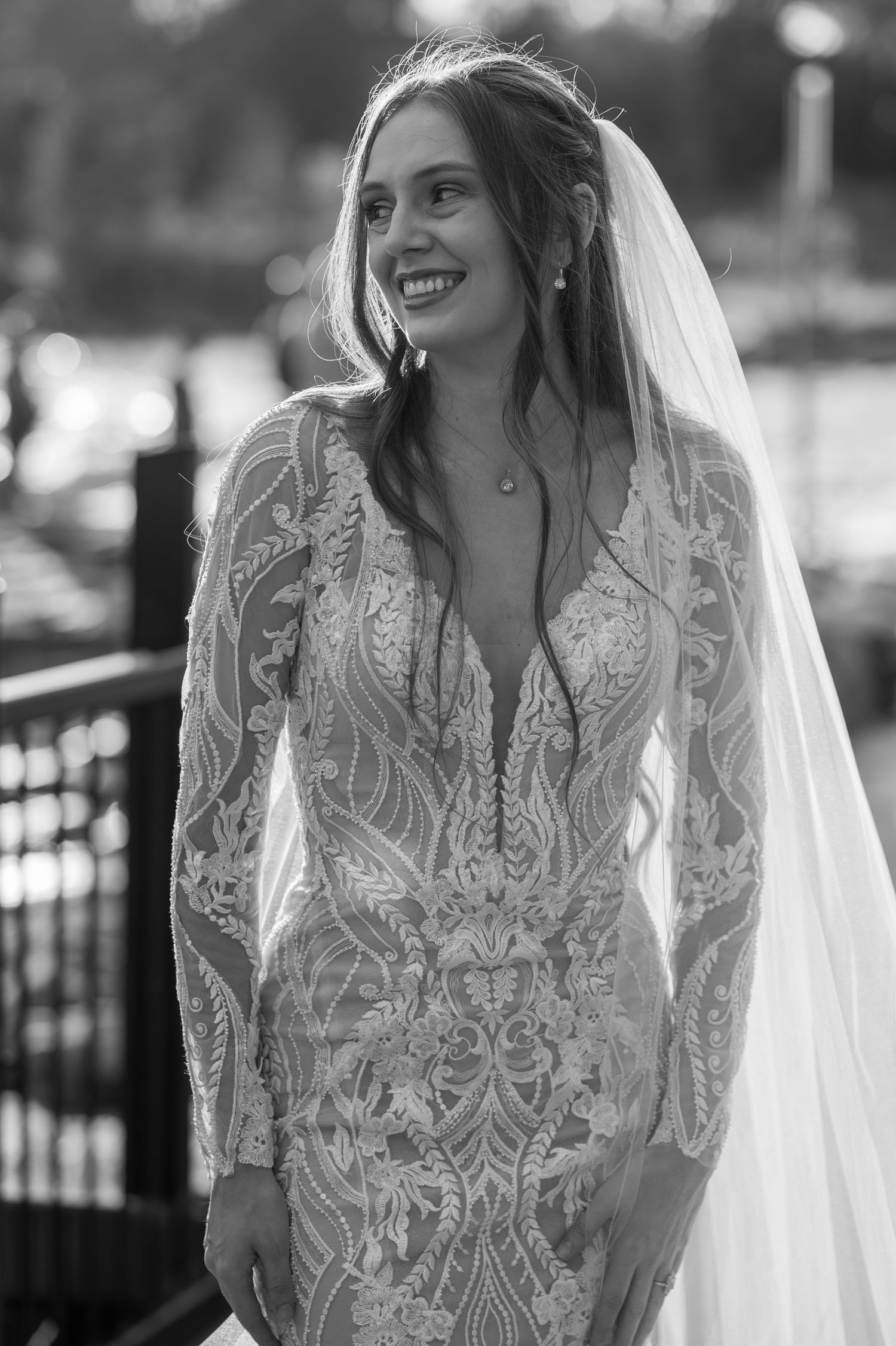 Elegant lace wedding dress with long sleeves captured in a series of black and white portraits.