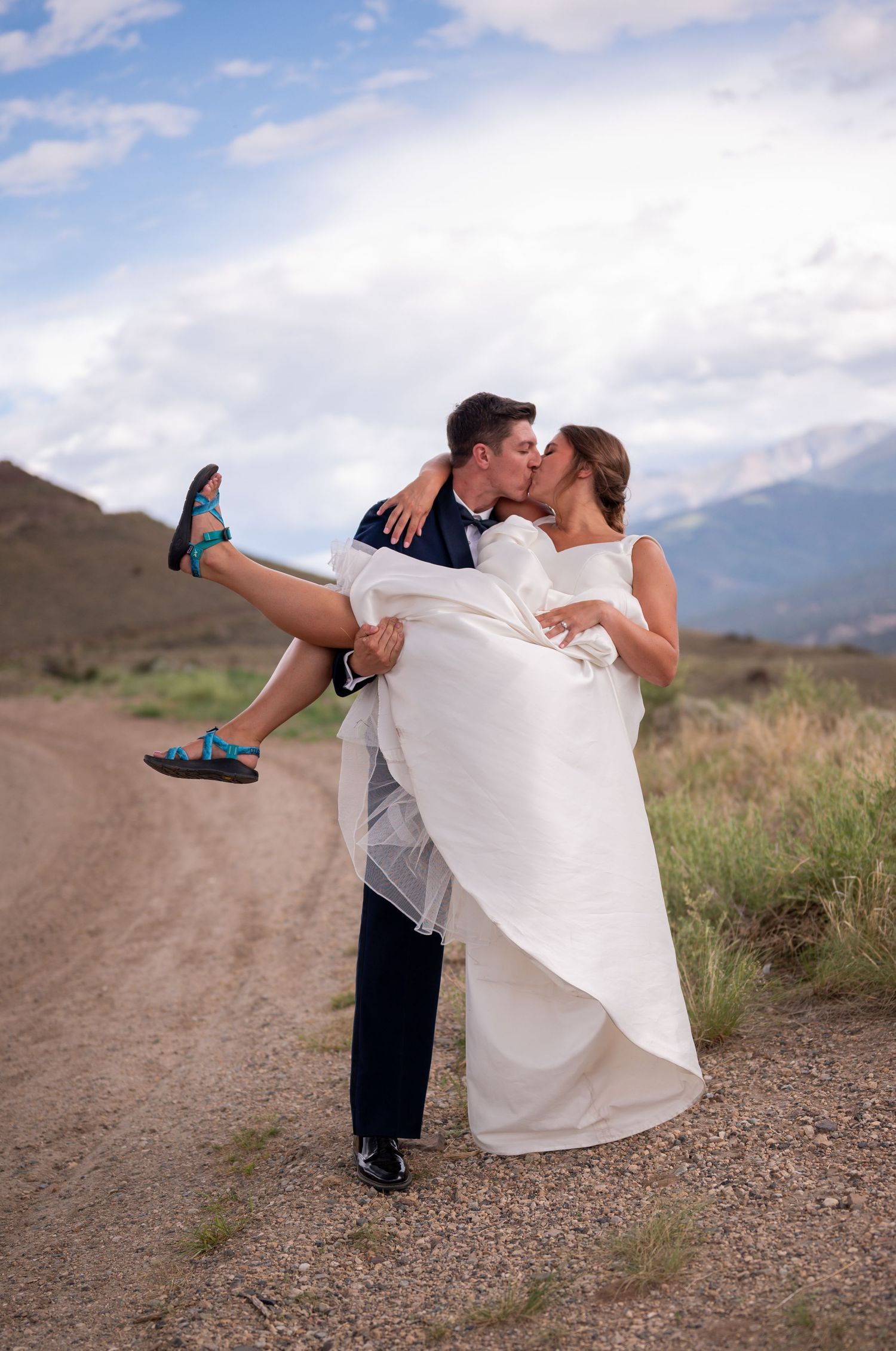 Romantic wedding photo sequence with mountain backdrop and dramatic dip pose.