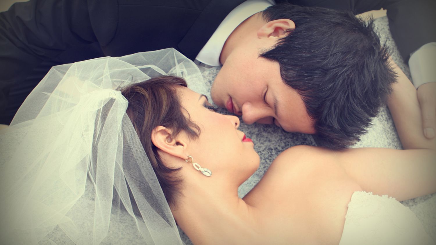 Intimate portrait of couple sharing tender moment in wedding attire.