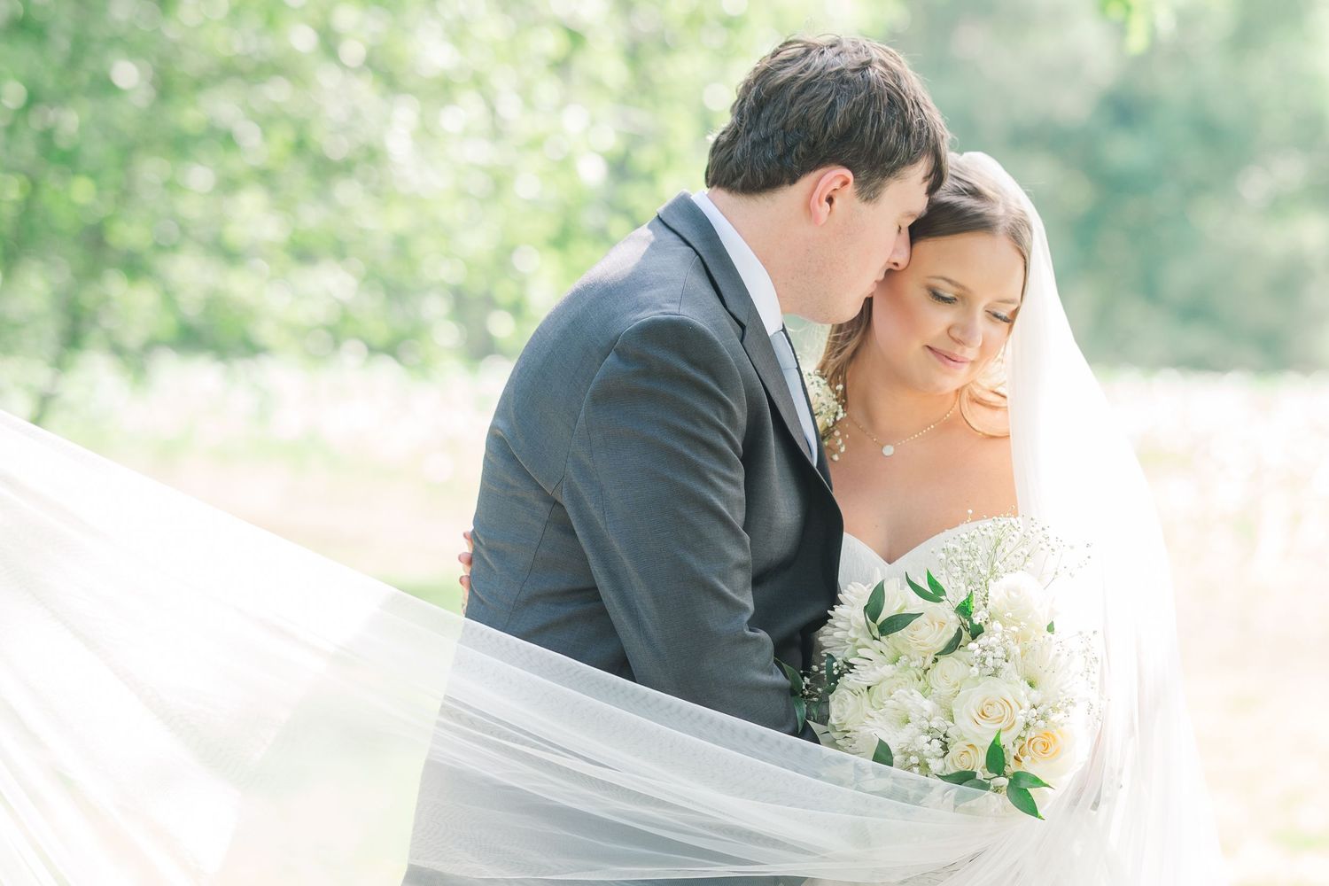 Romantic wedding portraits captured in a sunlit garden setting.