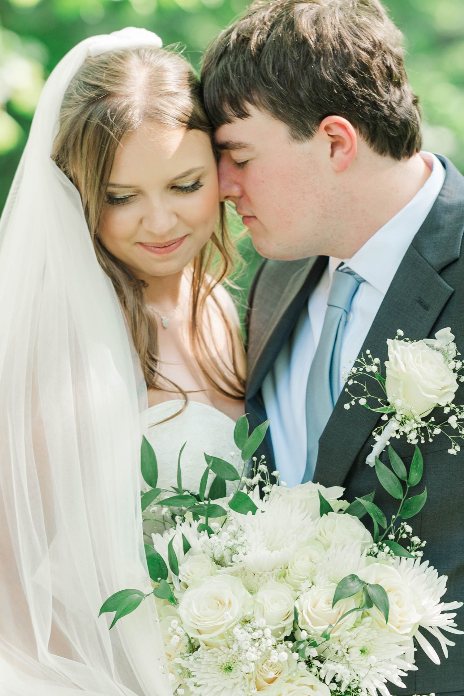 Romantic close-up portraits with white floral bouquet in garden setting.