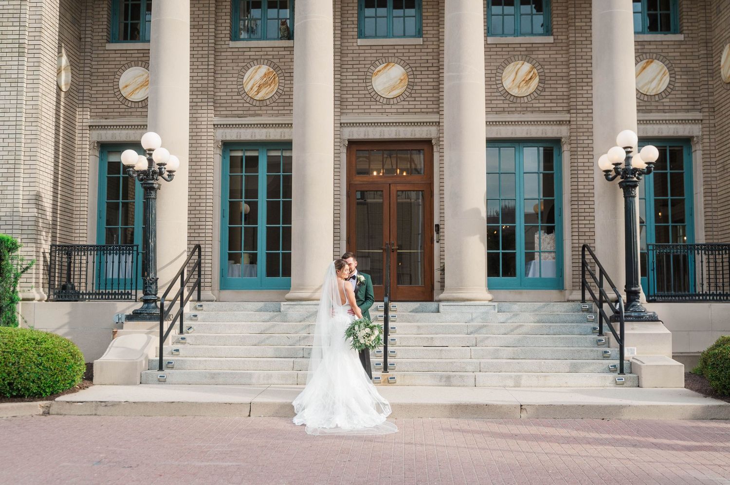 Classic stone building exterior with turquoise windows and white columns creating an elegant architectural facade. Historic Post Office VA