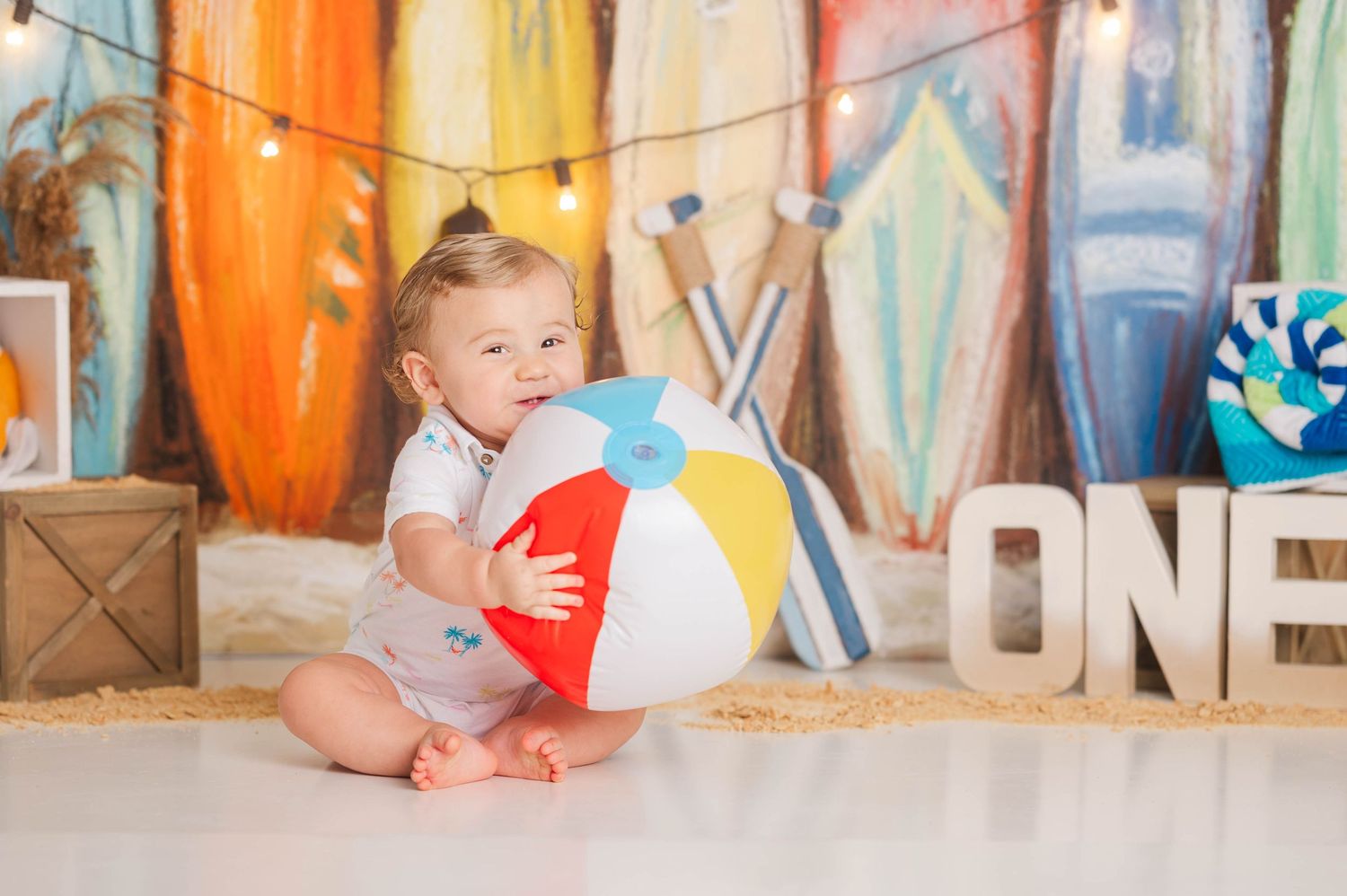 Colorful first birthday party setup with string lights and festive decorations.