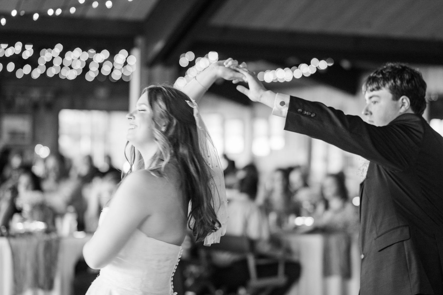 Wedding reception dance floor with twinkling lights creating a romantic atmosphere.