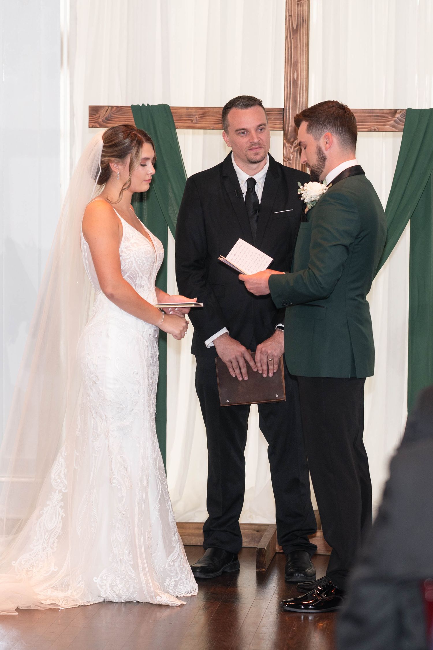 Wedding ceremony in progress with couple and officiant at the altar.