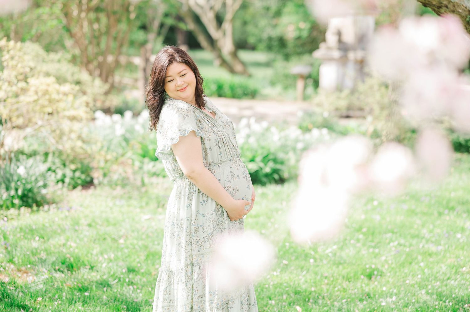 Candid family moments captured in a dreamy spring garden setting.