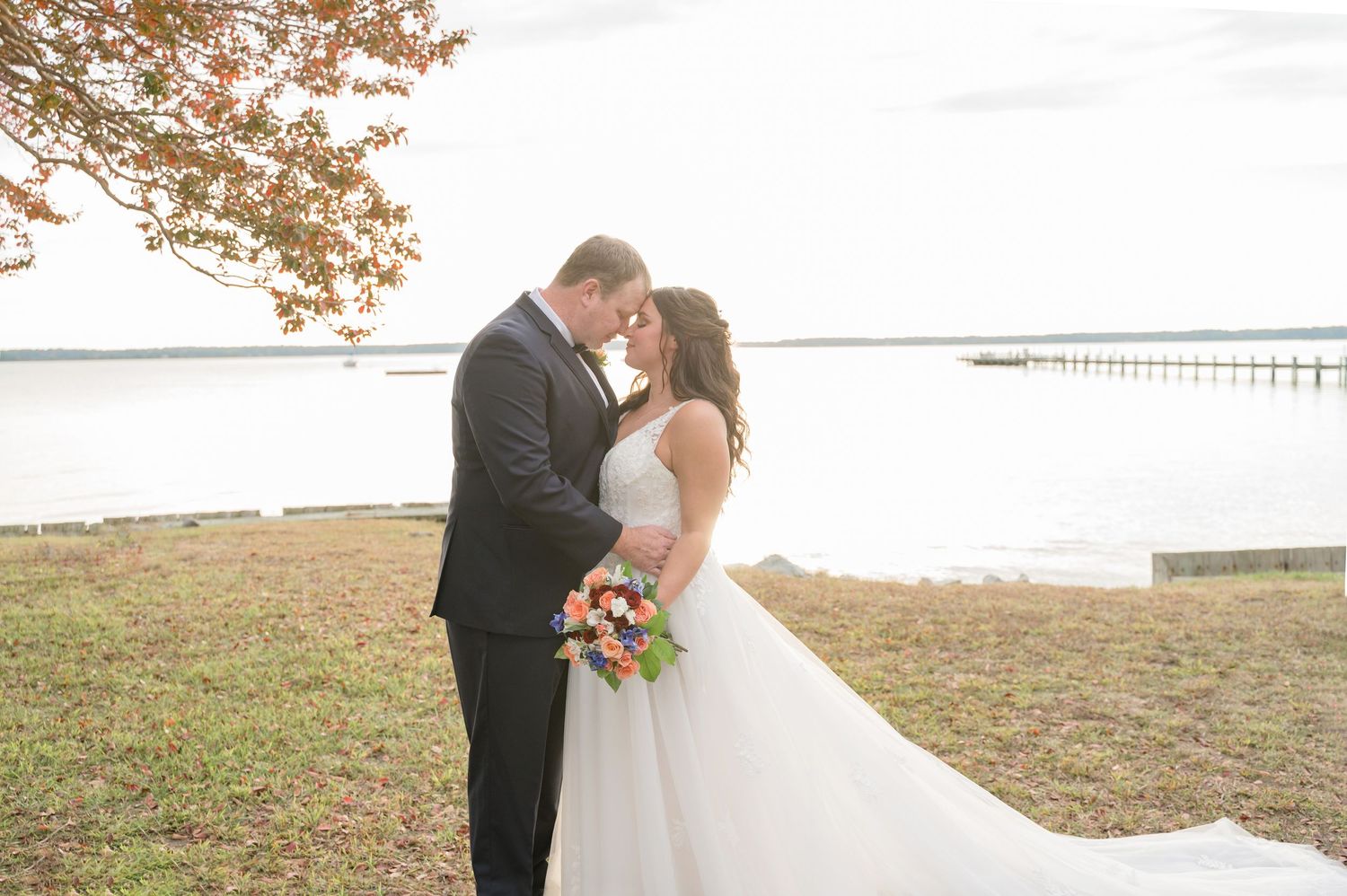 Waterfront wedding ceremony photos with natural landscape in background.