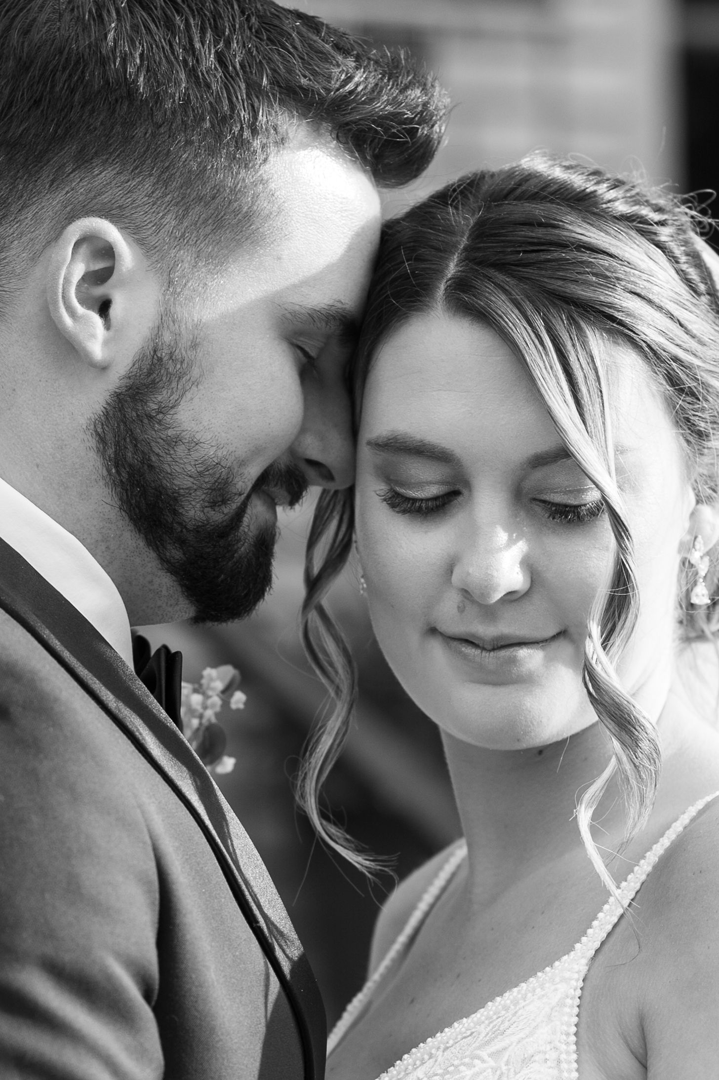 Intimate black and white wedding portrait series showing tender romantic moments between newlyweds.