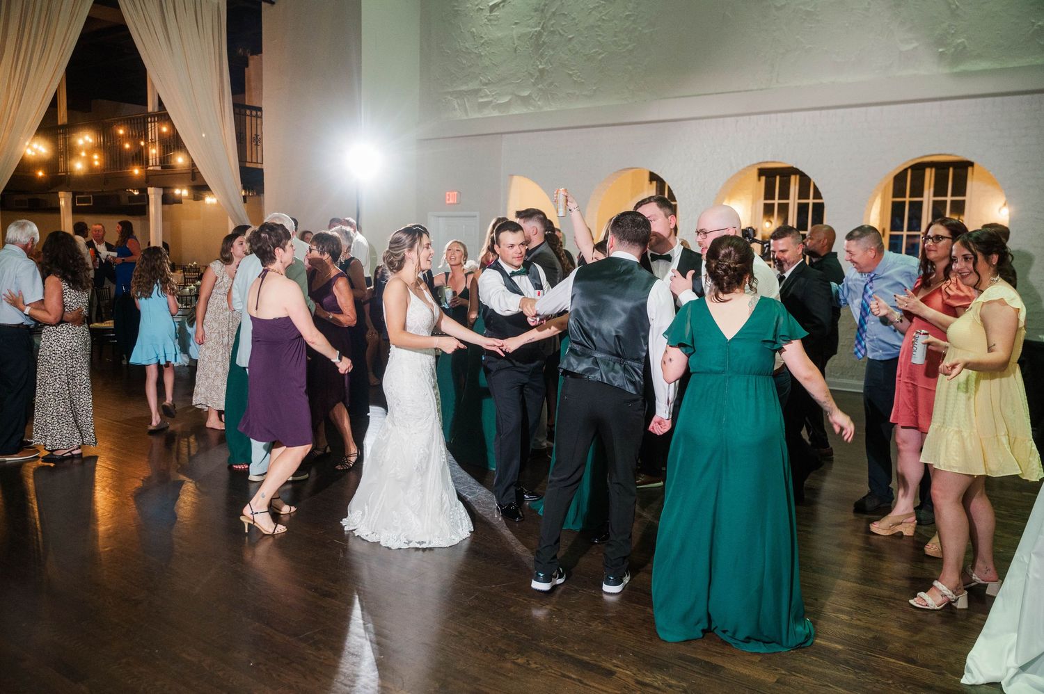 Wedding reception dance floor filled with guests enjoying the celebration.