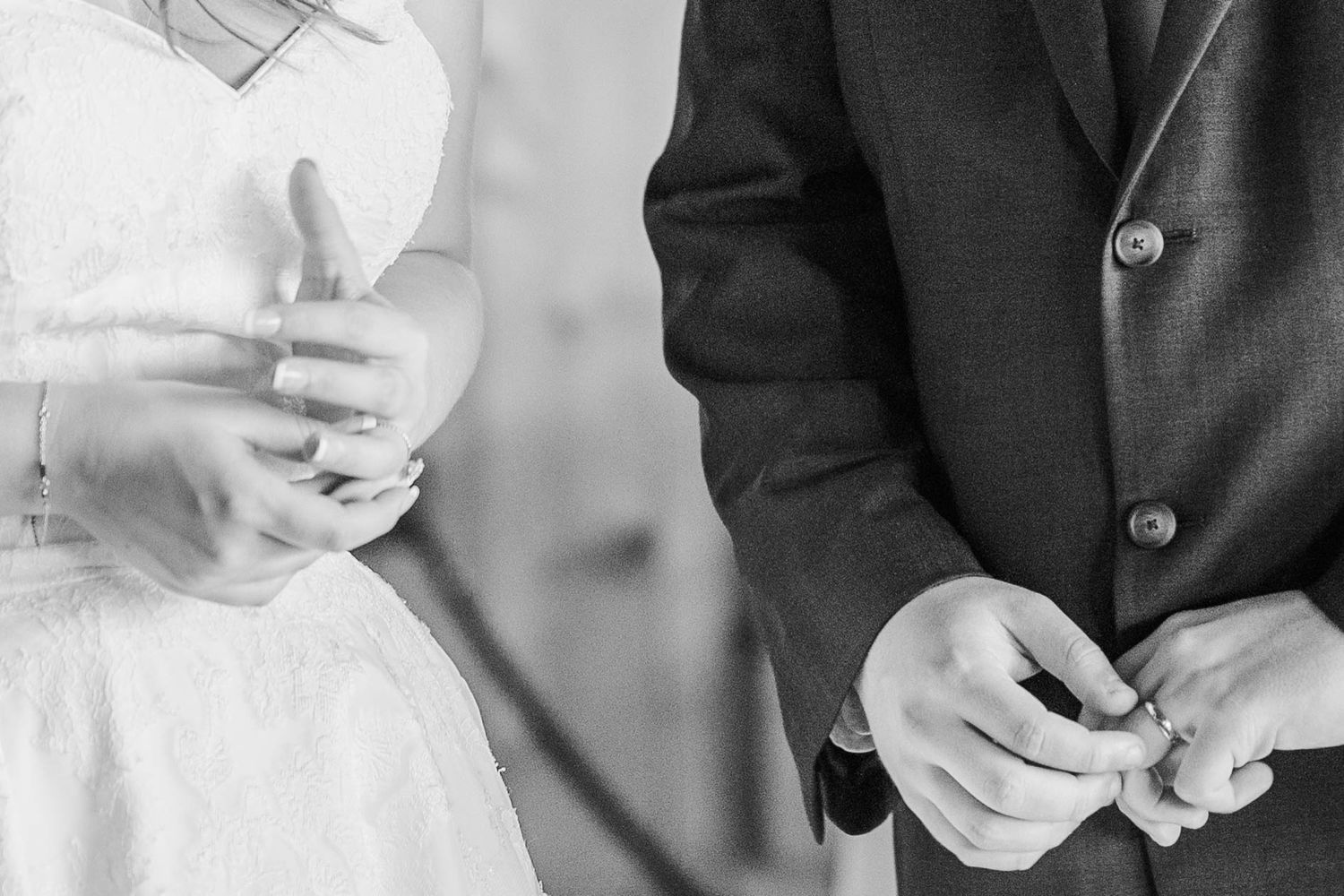 Wedding party members adjusting boutonnieres and preparing for ceremony.