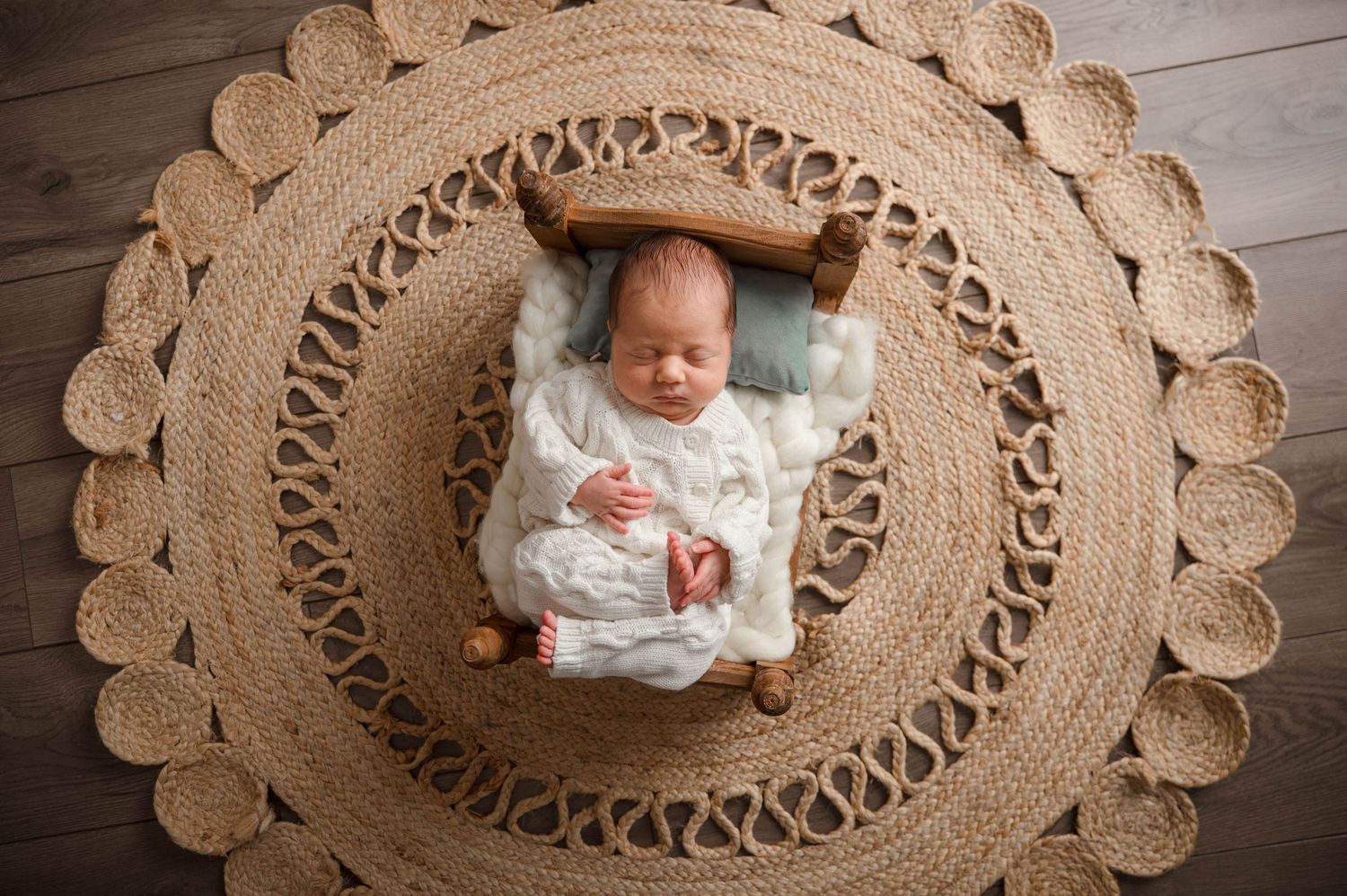 Newborn baby in studio on bed.