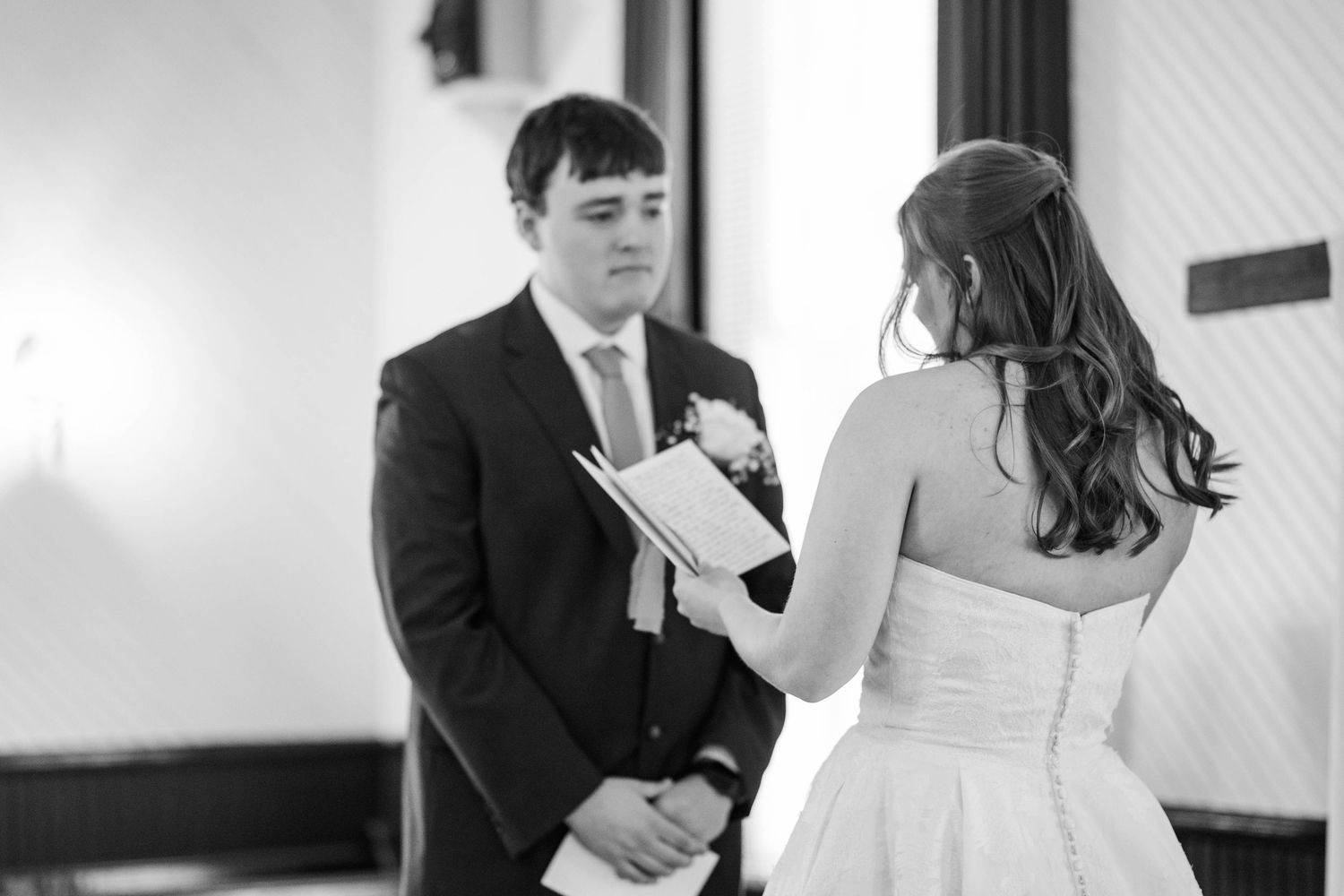 Black and white candid moments captured during wedding preparation.