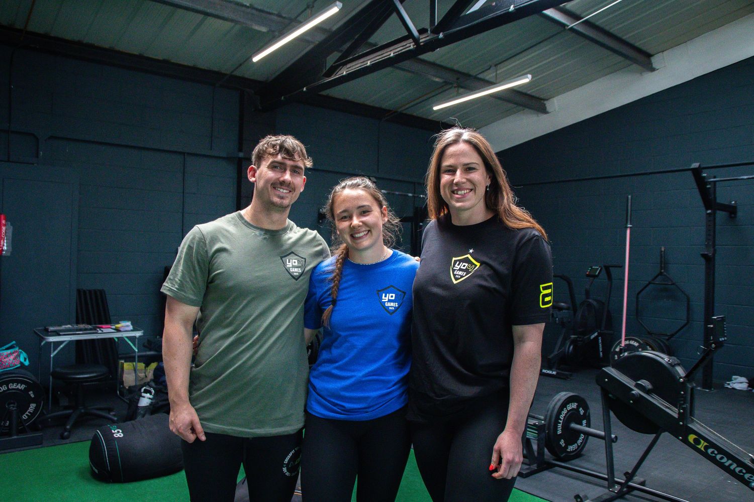 People exercising in a group fitness session at a modern indoor gym facility.