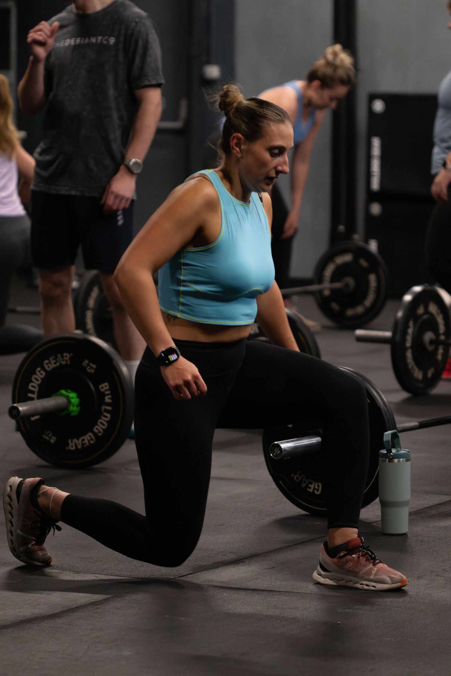 Four sequential photos showing proper deadlift form with an athlete demonstrating the movement in a gym setting.