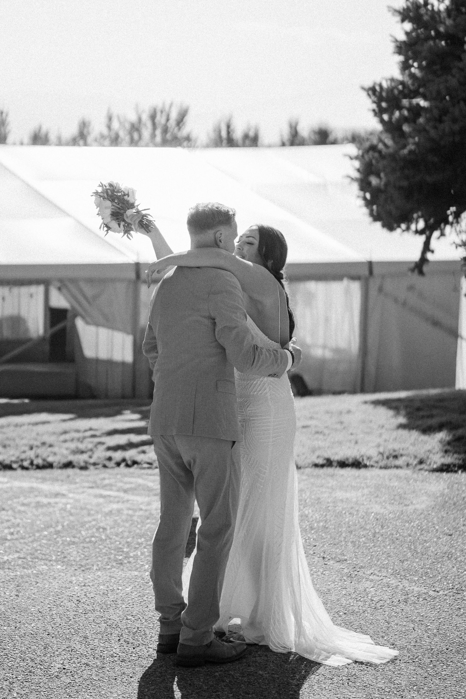 A romantic black and white photo sequence shows a couple embracing outdoors on their wedding day.
