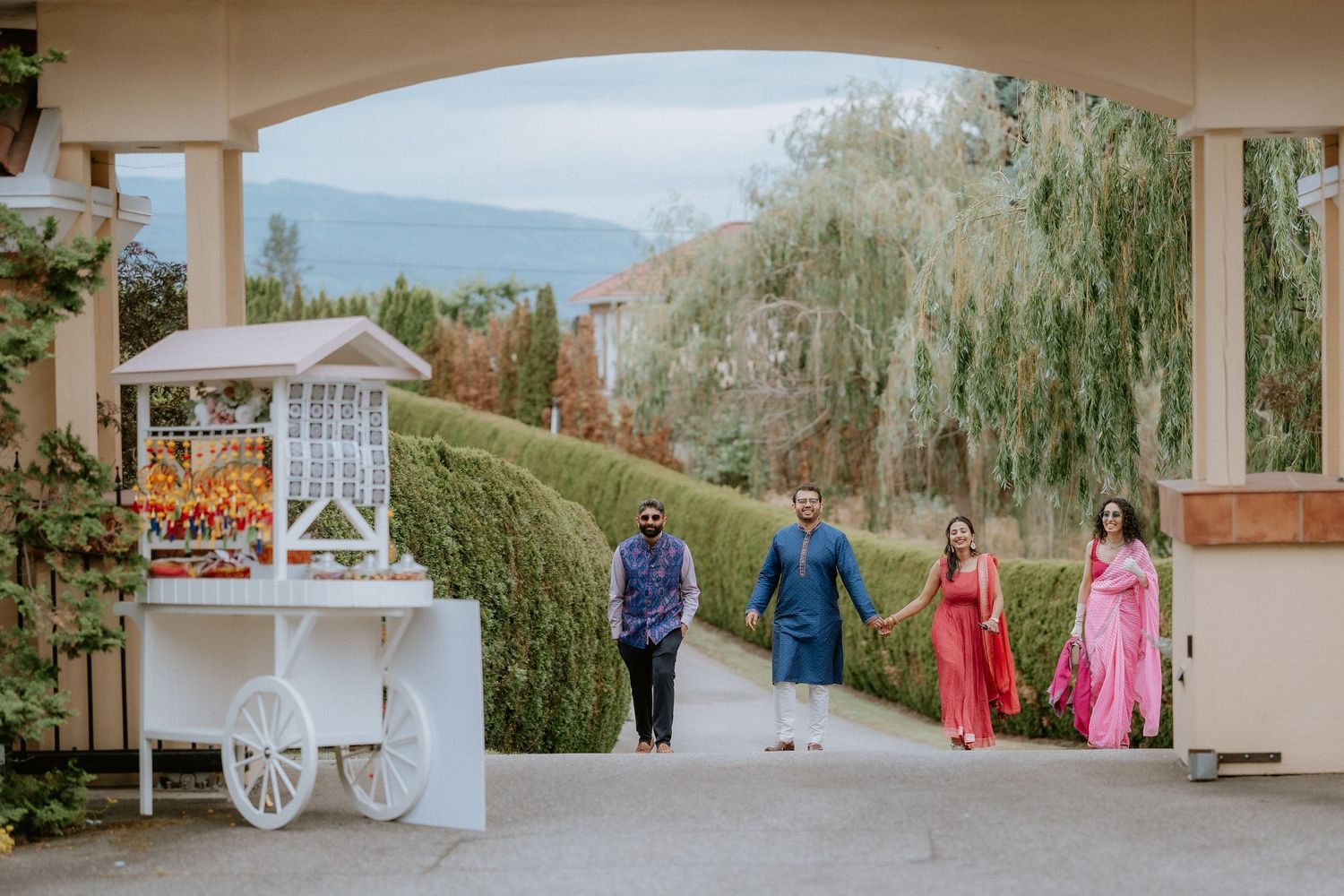 Wedding venue panorama showing outdoor ceremony and reception areas with rustic decor and natural landscaping.