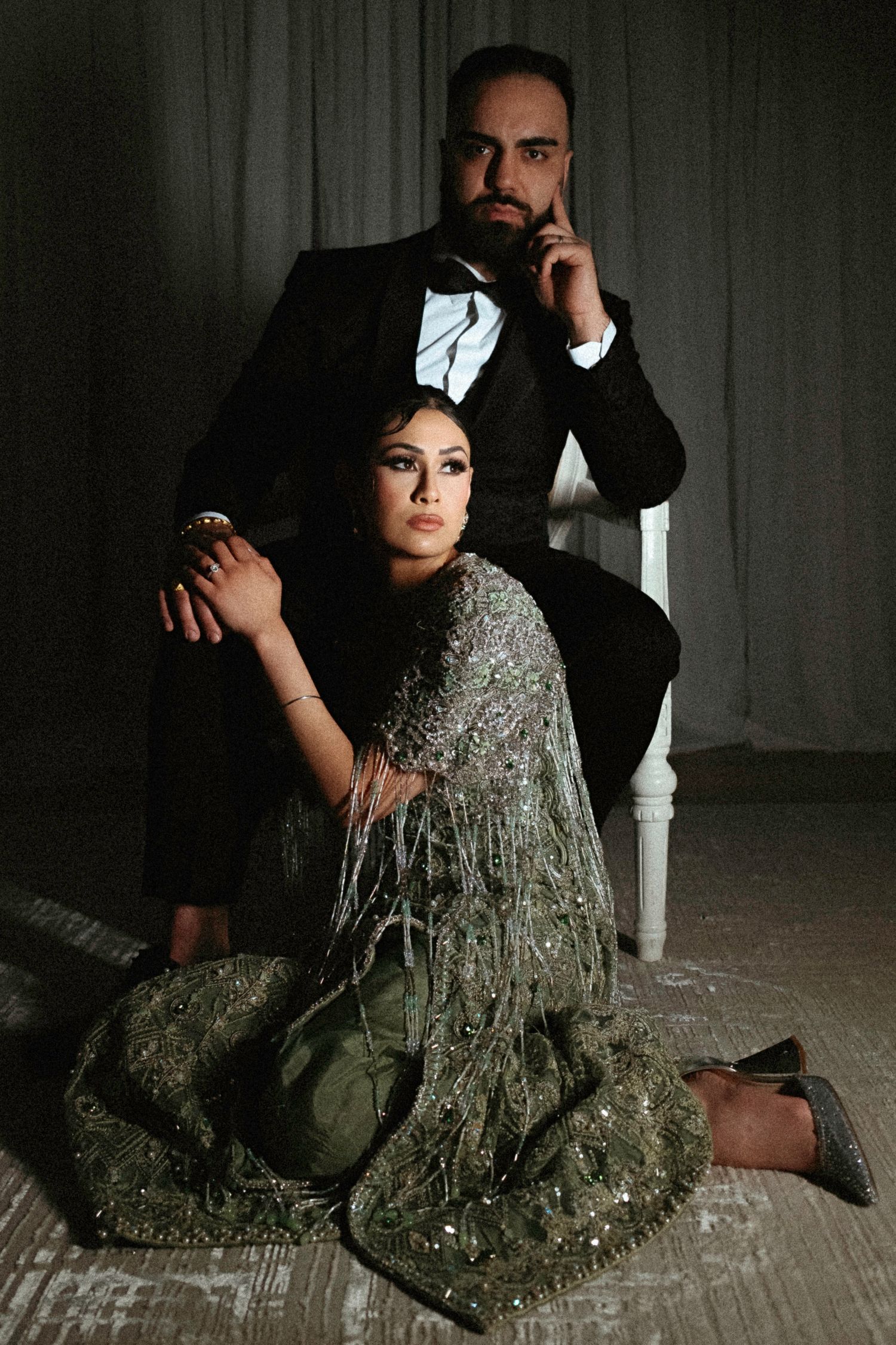 Artistic portrait series featuring two people in formal attire posing dramatically on a light-colored floor.