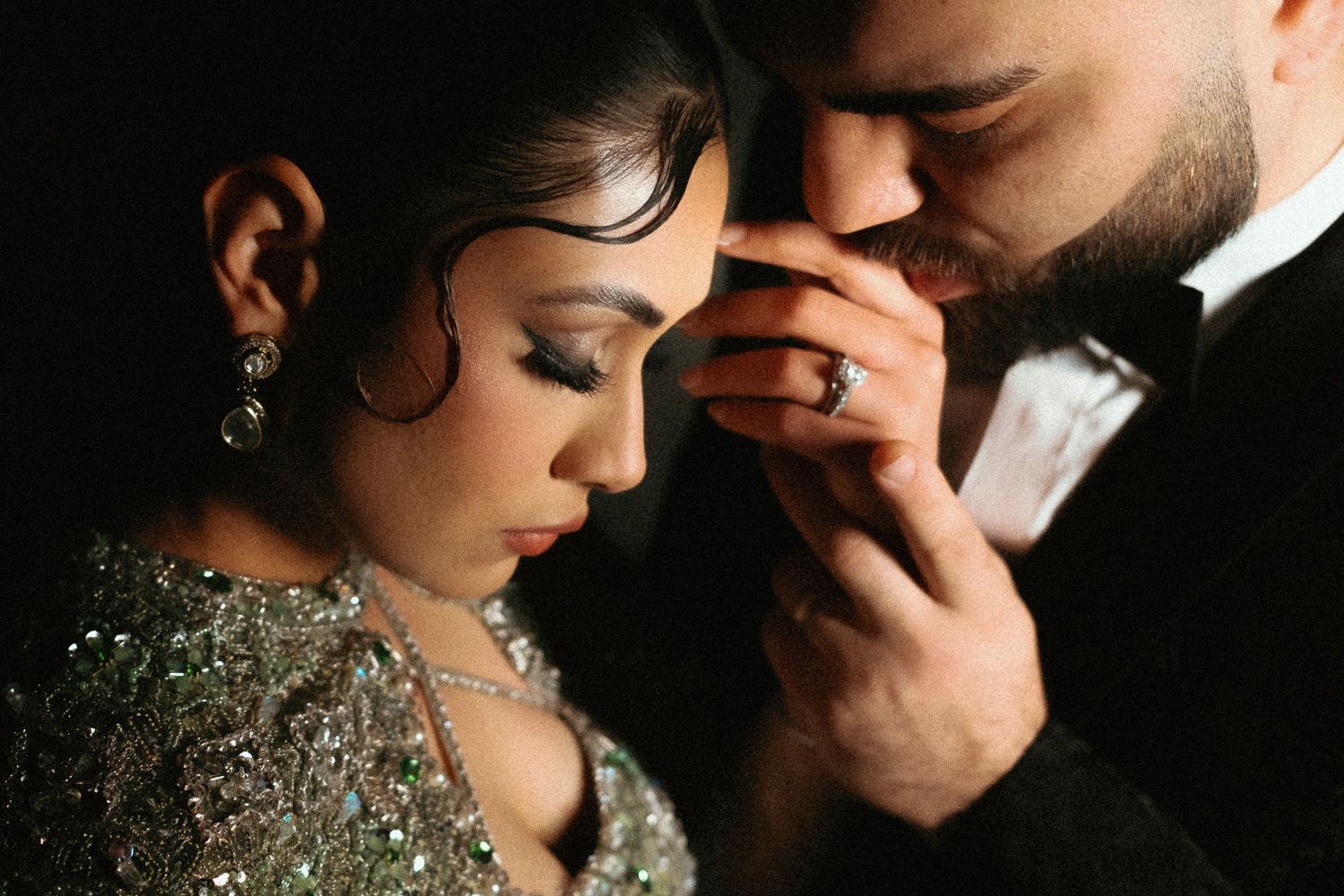 Romantic couple in wedding attire sharing intimate moments in black and white photography series.