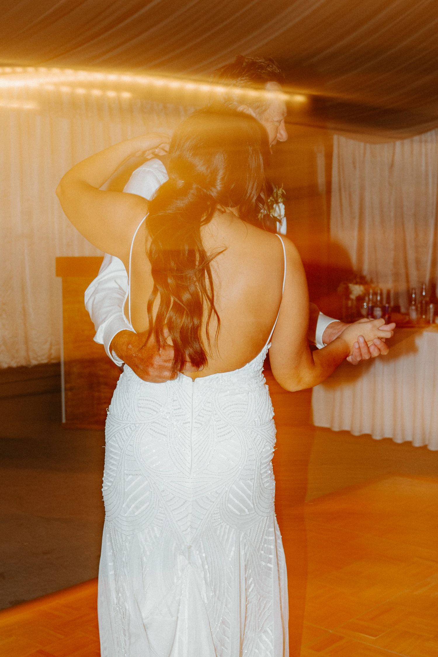 Motion-blurred photos of wedding guests dancing at the reception.