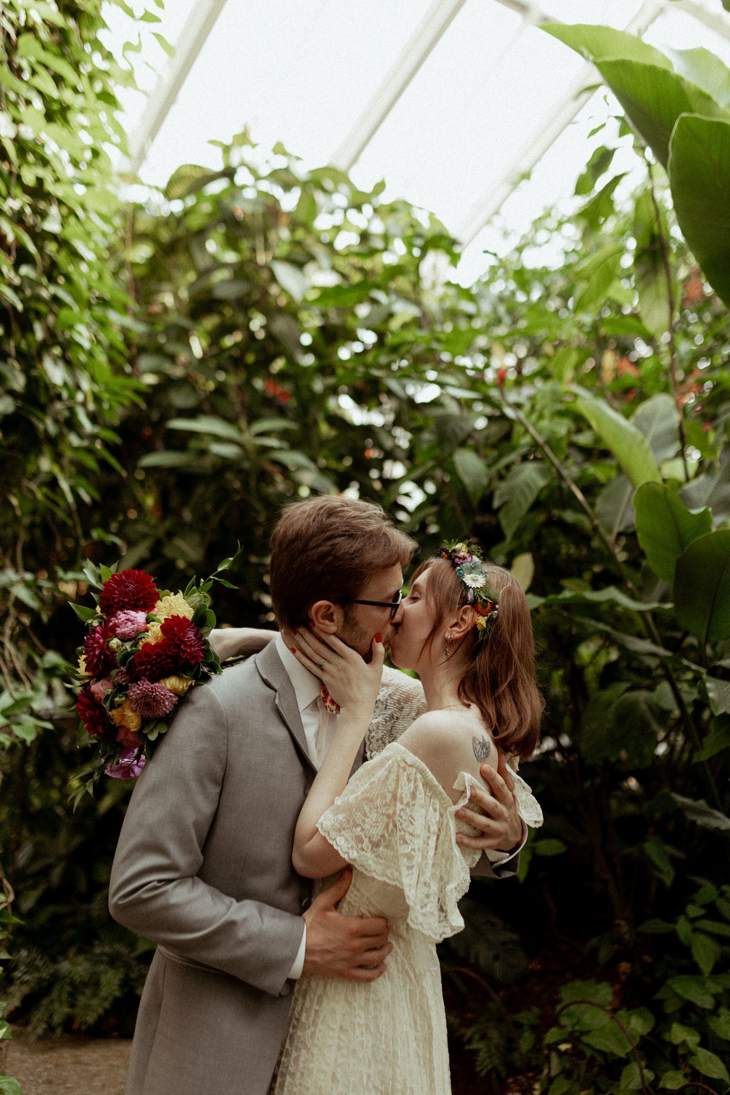 Romantic greenhouse wedding scene with lush greenery and natural lighting.