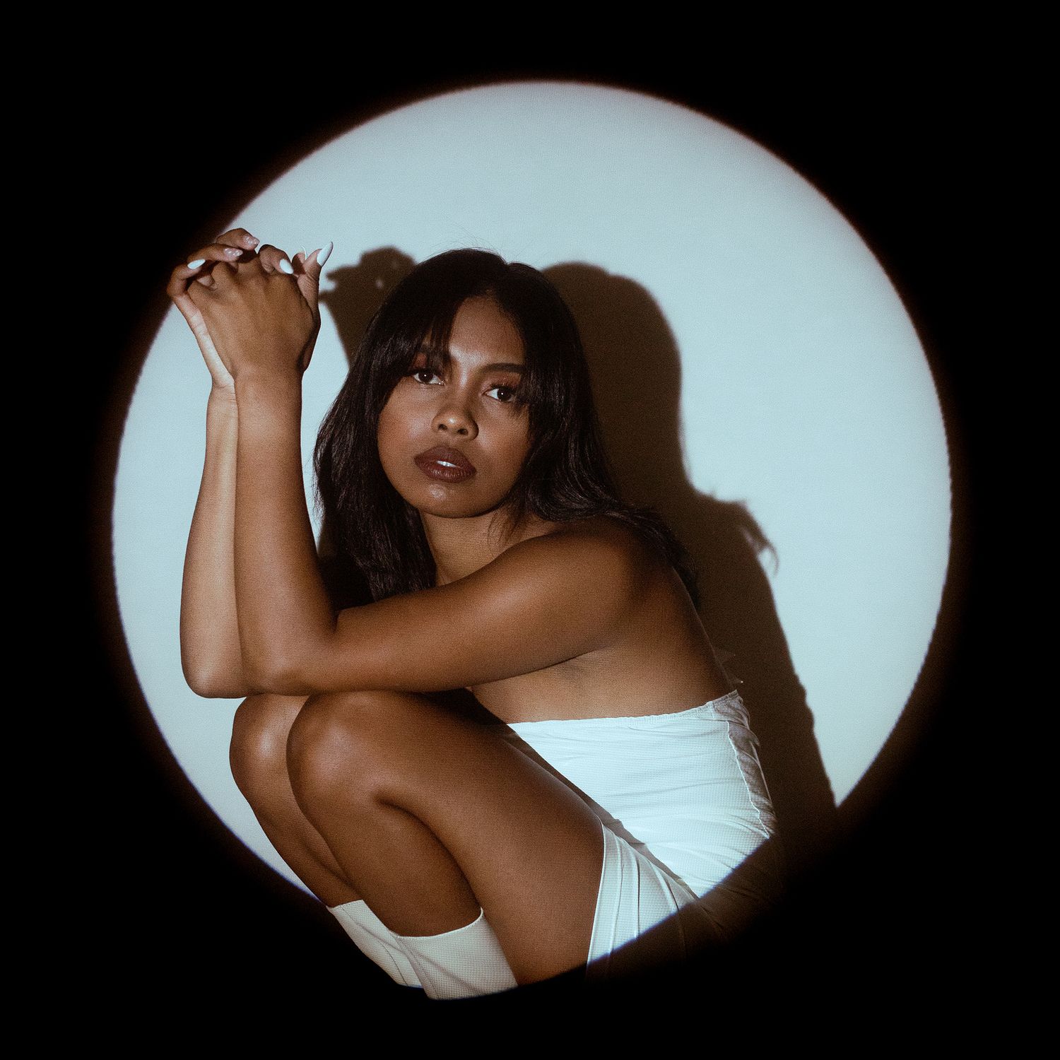 Artistic black and white portraits through circular frame showing movement.