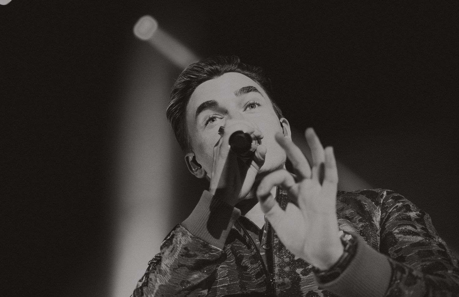 Black and white performance shot capturing intense stage energy.