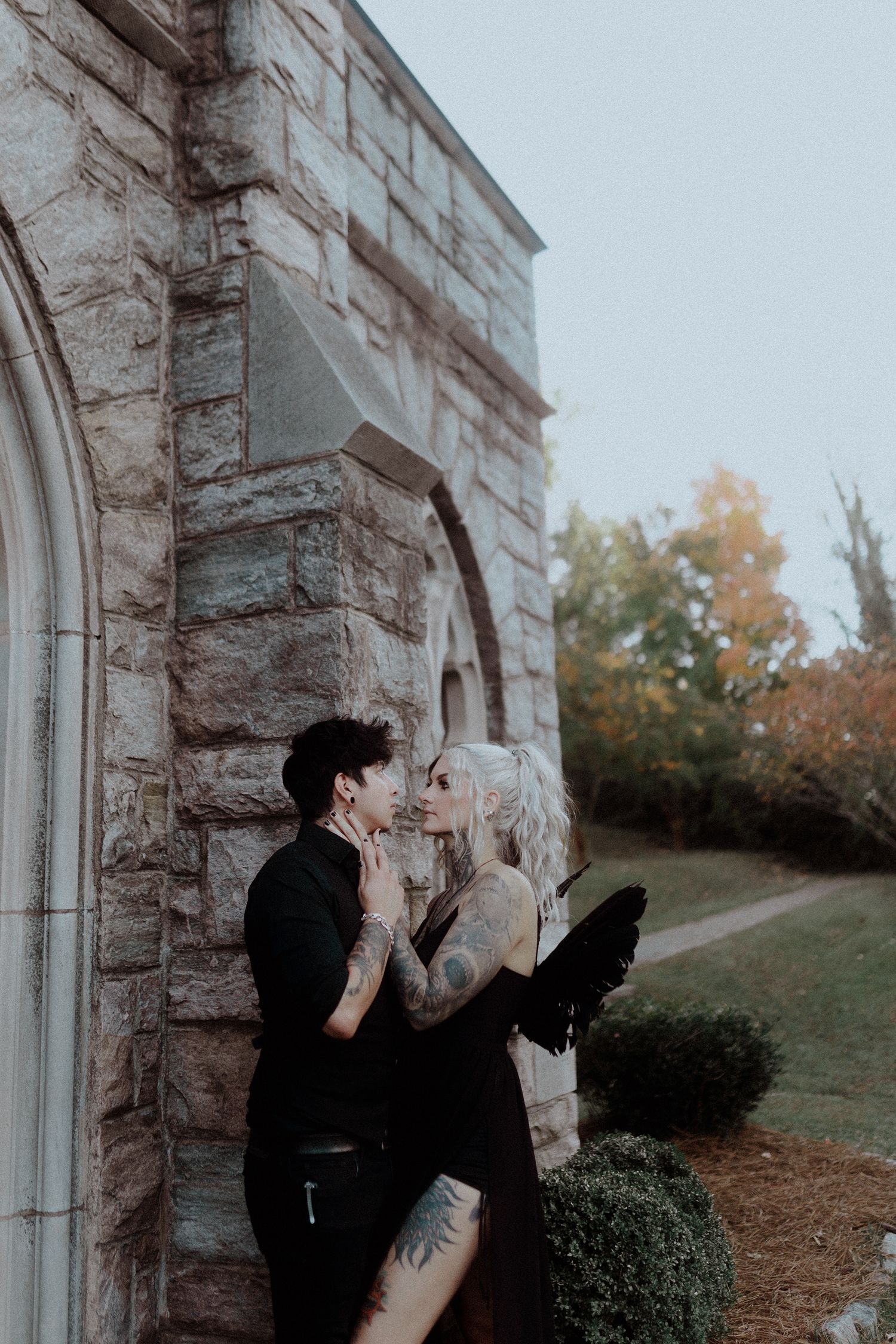 Romantic couple photoshoot sequence against stone building exterior.