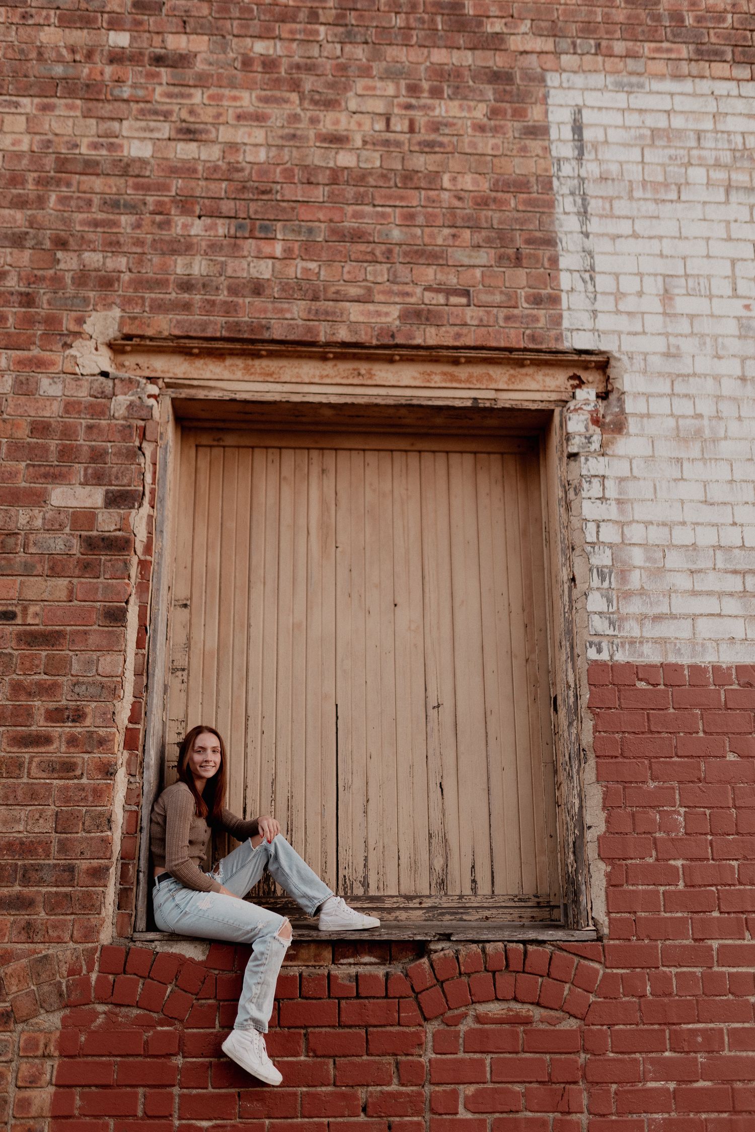 Artistic photo sequence of person sitting in brick window frames.