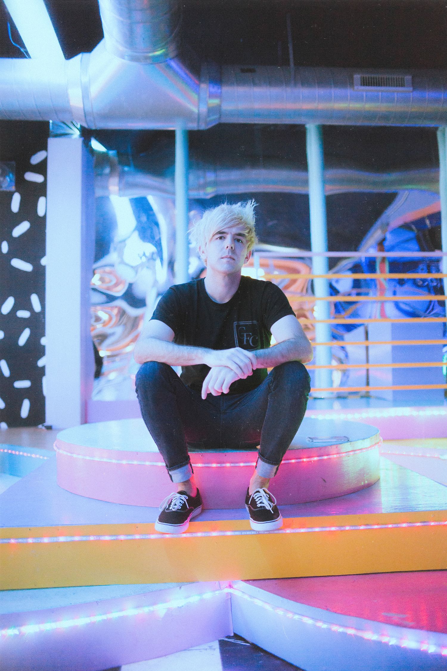 Dynamic photo series on colorful illuminated platform with neon lighting effects.