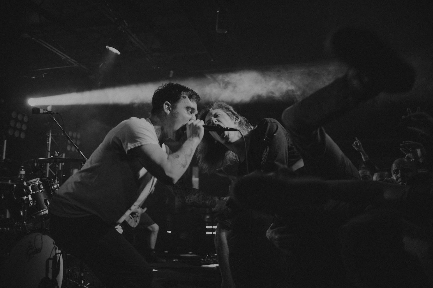 Dynamic black and white performance shot capturing intense stage energy.