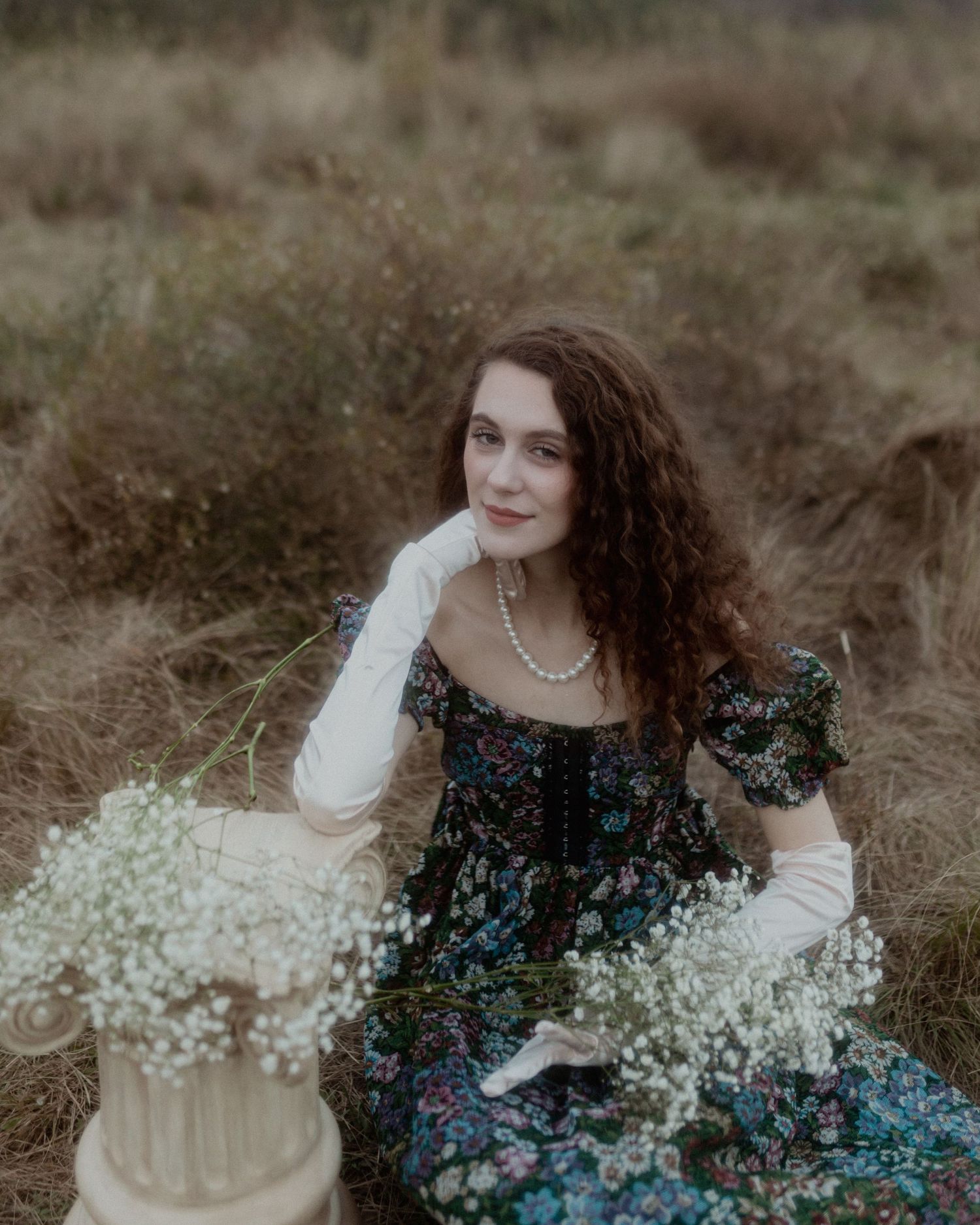 A whimsical portrait with baby's breath flowers in a natural outdoor setting.