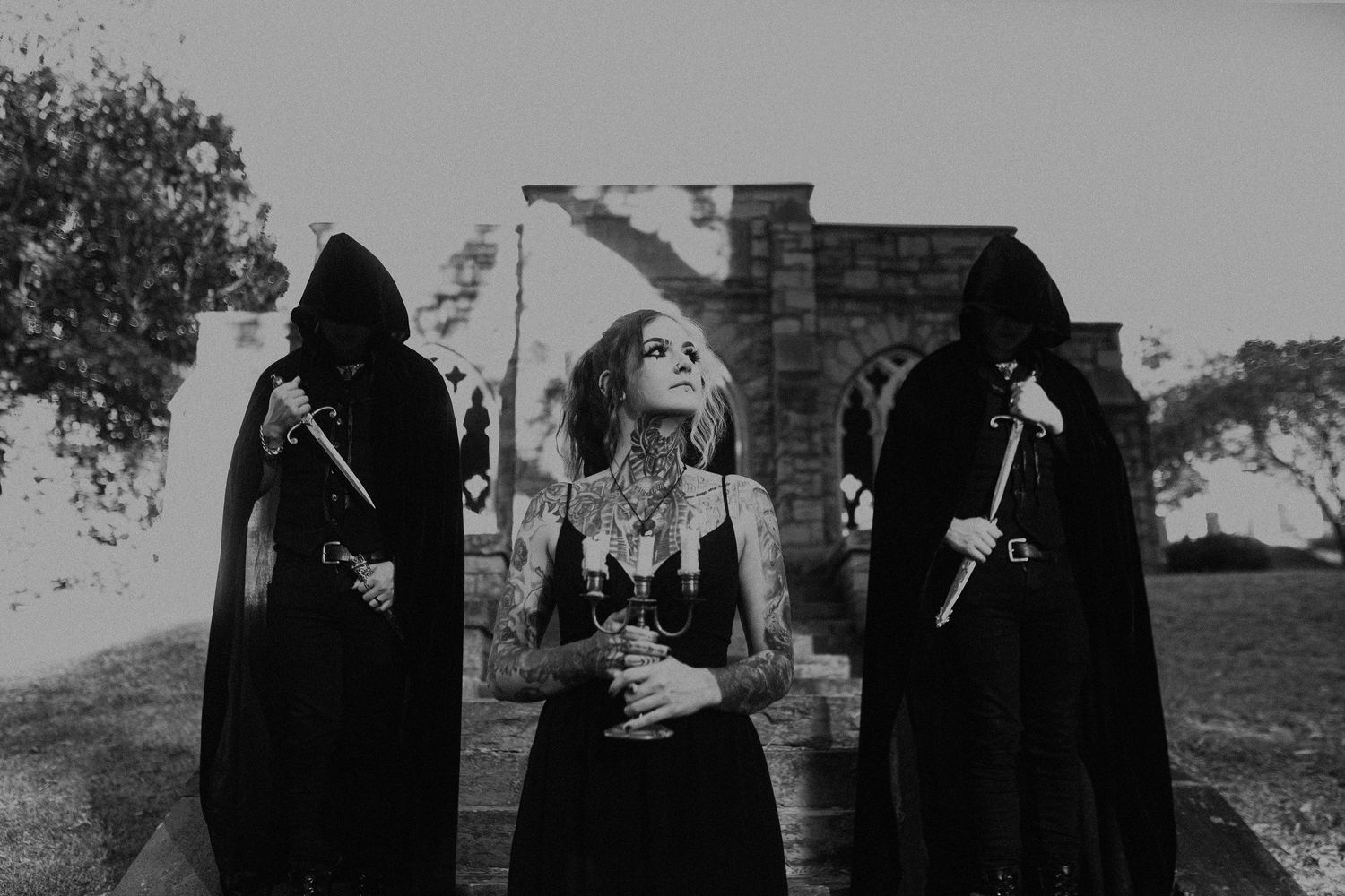 Black and white photo series of figures in dark clothing standing outdoors.
